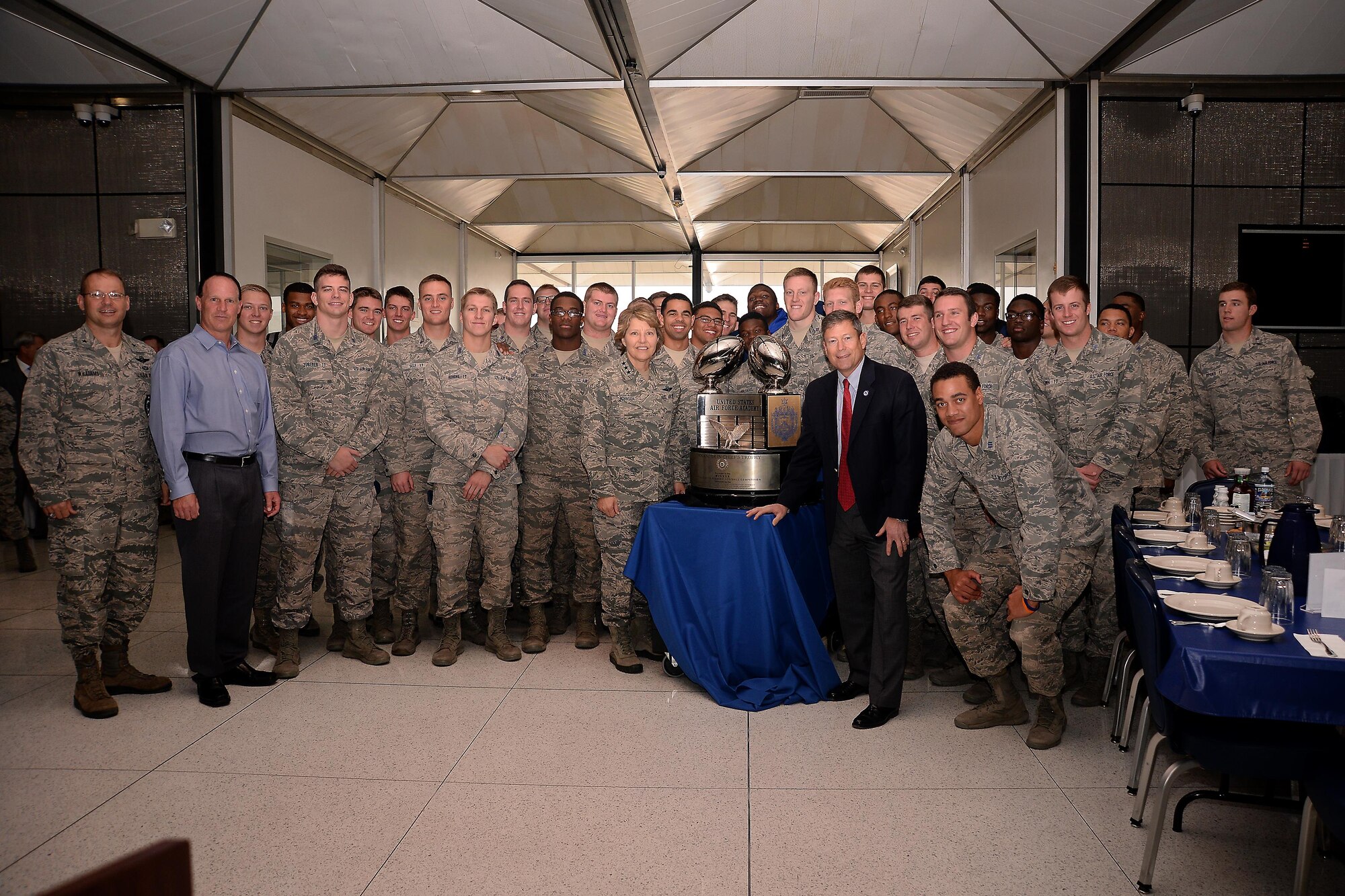 Lt. Gen. Michelle Johnson (center left), the superintendent of the U.S. Air Force Academy, and Dr. Jim Knowlton, the director of the Academy's Athletics Department (center right), stand besides the Commander-in-Chief's Trophy Nov. 17, 2017, in Mitchell Hall.  Johnson presented the trophy to the Cadet Wing from the Staff Tower during a long round of applause from cadets. Standing with Johnson and Knowlton are Falcon Football head coach Troy Calhoun, members of the Air Force Falcons, and Brig. Gen. Stephen Williams, the commander of the Cadet Wing. (U.S. Air Force photo/Darcie Ibidapo)
