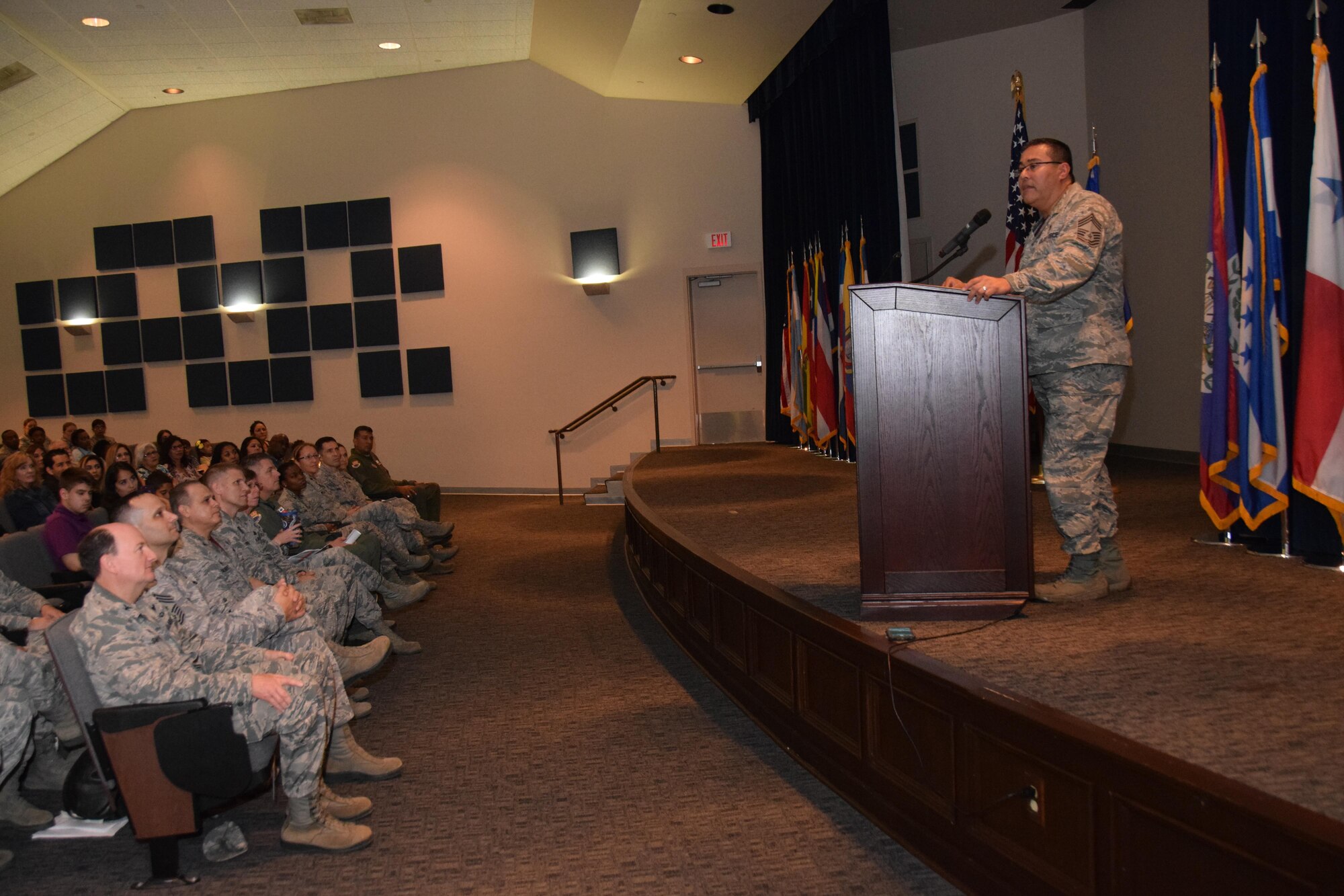 Chief Master Sgt. Christopher Florez, 433rd Medical Squadron medical services superintendent, addresses 433rd Airlift Wing Community College of the Air Force graduates during his commencement speech at the wing's CCAF graduation ceremony Nov. 5, 2016 at the Inter American Air Forces Academy auditorium on Joint Base San Antonio-Lackland, Texas. More than 100 433rd AW Airmen earned their degrees. The CCAF is the world’s largest degree granting institution of higher learning. (U.S. Air Force photo by Tech. Sgt. Carlos J. Treviño)