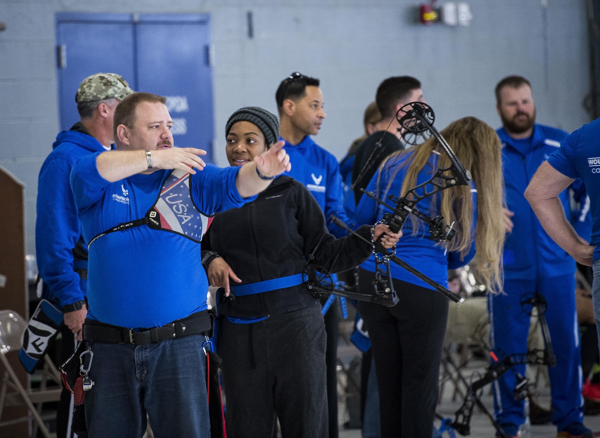 Tim McDonough, an Air Force Wounded Warrior Program assistant archery coach, gives pointers to Senior Airman Raviro Mutumhe, of the 633rd Medical Group, during the Northeast Warrior CARE Event on Joint Base Andrews, Md., Nov. 18, 2016. The AFW2 regional CARE event provided a holistic opportunity for wounded warriors to enhance the four domains -- physical, mental, spiritual and social – of Comprehensive Airman Fitness. (U.S. Air Force photo/Staff Sgt. Christopher Gross)