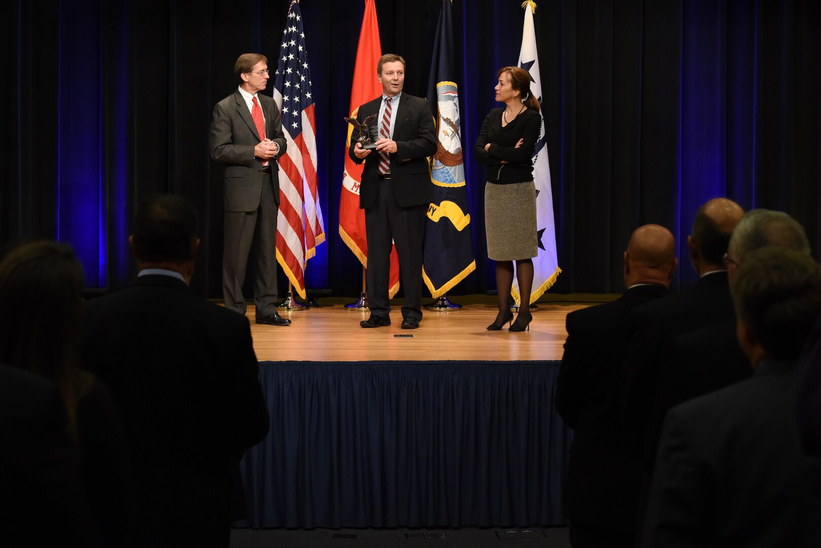 Assistant Secretary of the Navy (Research, Development and Acquisition) Sean Stackley (left) presented Naval Sea Systems Command’s Mike Gutermuth the Rear Admiral Wayne E. Meyer Memorial Award as Janine Anne Davidson, Under Secretary of the United States Navy looks on during the 2016 Department of the Navy Acquisition Excellence Awards at the Pentagon, Nov. 17. 
