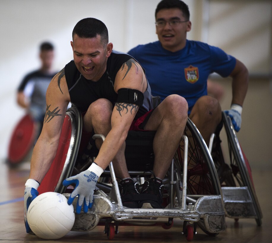 U.S. Marine Corps Gunnery Sgt. Andrew Cordova, Warrior CARE participant, picks up a ball while playing wheel chair rugby during the Northeast Region Warrior CARE Event at Joint Base Andrews, Md., Nov. 14, 2016. Wheel chair rugby was one of many sports the wounded warriors participated in, including sitting volleyball, wheel chair basketball, archery, golf, track, rowing and shooting. The events are a part of a week-long program that features education in Caregiver Support, Adaptive and Rehabilitative Sports, Recovering Airman Mentorship, and Employment and Career Readiness. (U.S. Air Force photo by Senior Airman Philip Bryant)
