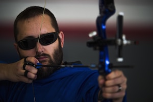 Josh Leary, Retired U.S. Air Force and wounded warrior, pulls back a bow as he prepares to shoot during the Northeast Region Warrior CARE Event at Joint Base Andrews, Md., Nov. 16, 2016. Leary is visually impaired and can only see four feet in front of him after losing most of his vision while serving in Afghanistan. Leary is given direction by a spotter during shooting. The events are a part of a week-long program that features education in Caregiver Support, Adaptive and Rehabilitative Sports, Recovering Airman Mentorship, and Employment and Career Readiness. (U.S. Air Force photo by Senior Airman Philip Bryant)