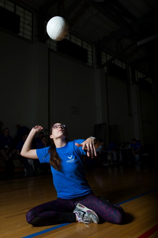 Senior Airman KieLani Vessar, 55th Medical Operations Squadron medical technician, prepares to hit a volleyball while playing sitting volleyball during the Northeast Region Warrior CARE Event at Joint Base Andrews, Md., Nov. 17, 2016. Vessar has disc disease that causes severe back pain that makes daily life difficult. The events are a part of a week-long program that features education in Caregiver Support, Adaptive and Rehabilitative Sports, Recovering Airman Mentorship, and Employment and Career Readiness. (U.S. Air Force photo by Senior Airman Philip Bryant)