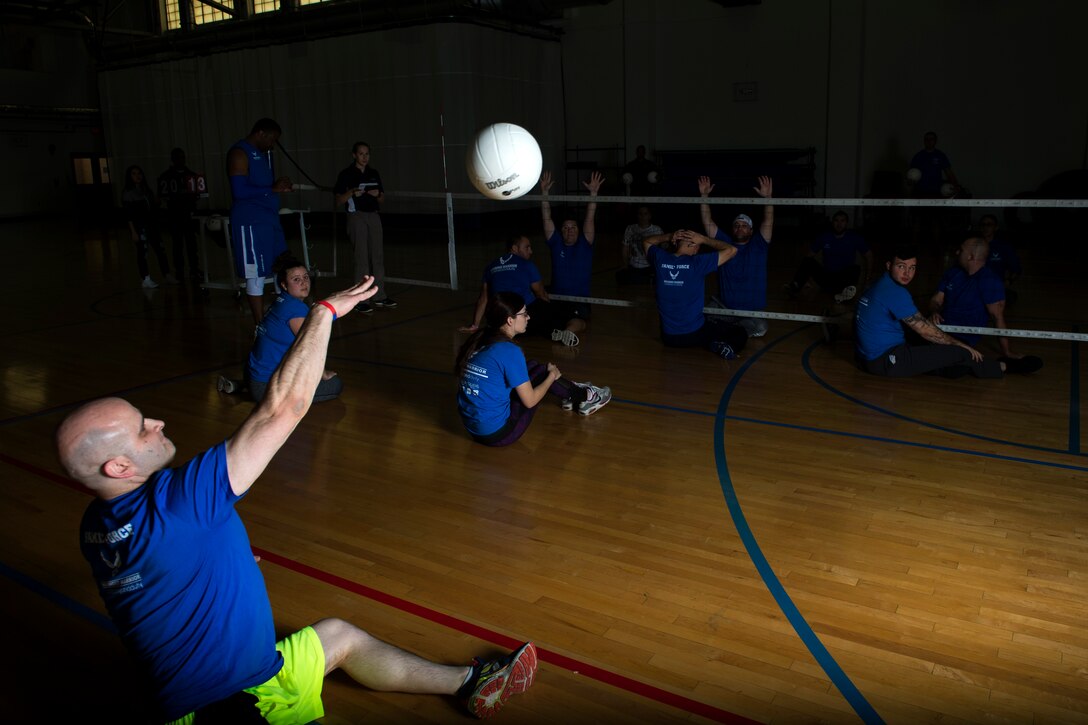Wounded warriors play seated volleyball during the Northeast Region Warrior CARE Event at Joint Base Andrews, Md., Nov. 17, 2016. The event is in conjunction with Warrior Care Month, a month dedicated to honoring the courage, resilience and accomplishments of wounded, ill and injured service members, their families and their caregivers. The events are a part of a week-long program that features education in Caregiver Support, Adaptive and Rehabilitative Sports, Recovering Airman Mentorship, and Employment and Career Readiness. (U.S. Air Force photo by Senior Airman Philip Bryant)