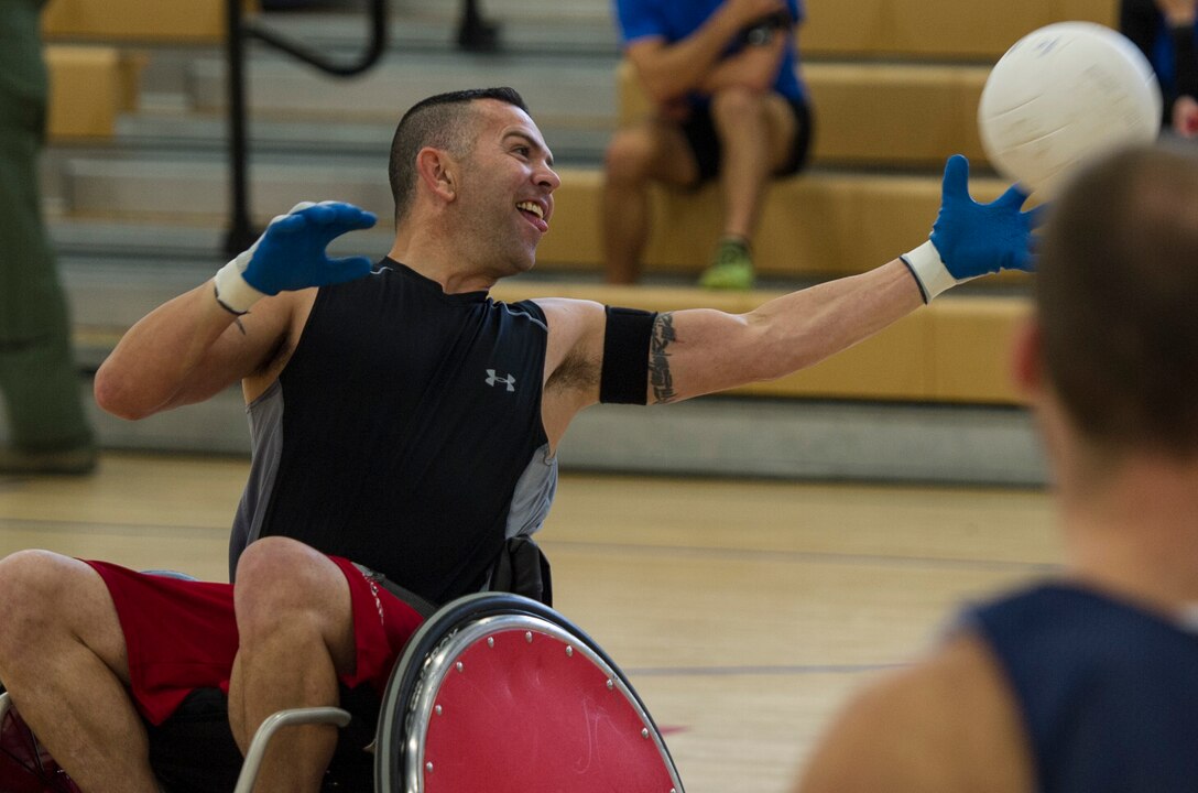 Gunnery Sgt. Andrew J. Cordova, Warrior CARE event participant, reaches for a volleyball at Joint Base Andrews, Md., Nov. 14, 2016. The attendees were composed of veterans and military members who have been wounded, ill or injured along with their caregivers who participated in several activities spanning the week. The Caregiver Support, Adaptive and Rehabilitative Sports, Recovering Airman Mentorship, and Employment and Career Readiness events ranged from swimming to guidance classes, providing a sense of normalcy to wounded warriors and promoting mental and physical wellness. (U.S. Air Force photo by Senior Airman Jordyn Fetter)