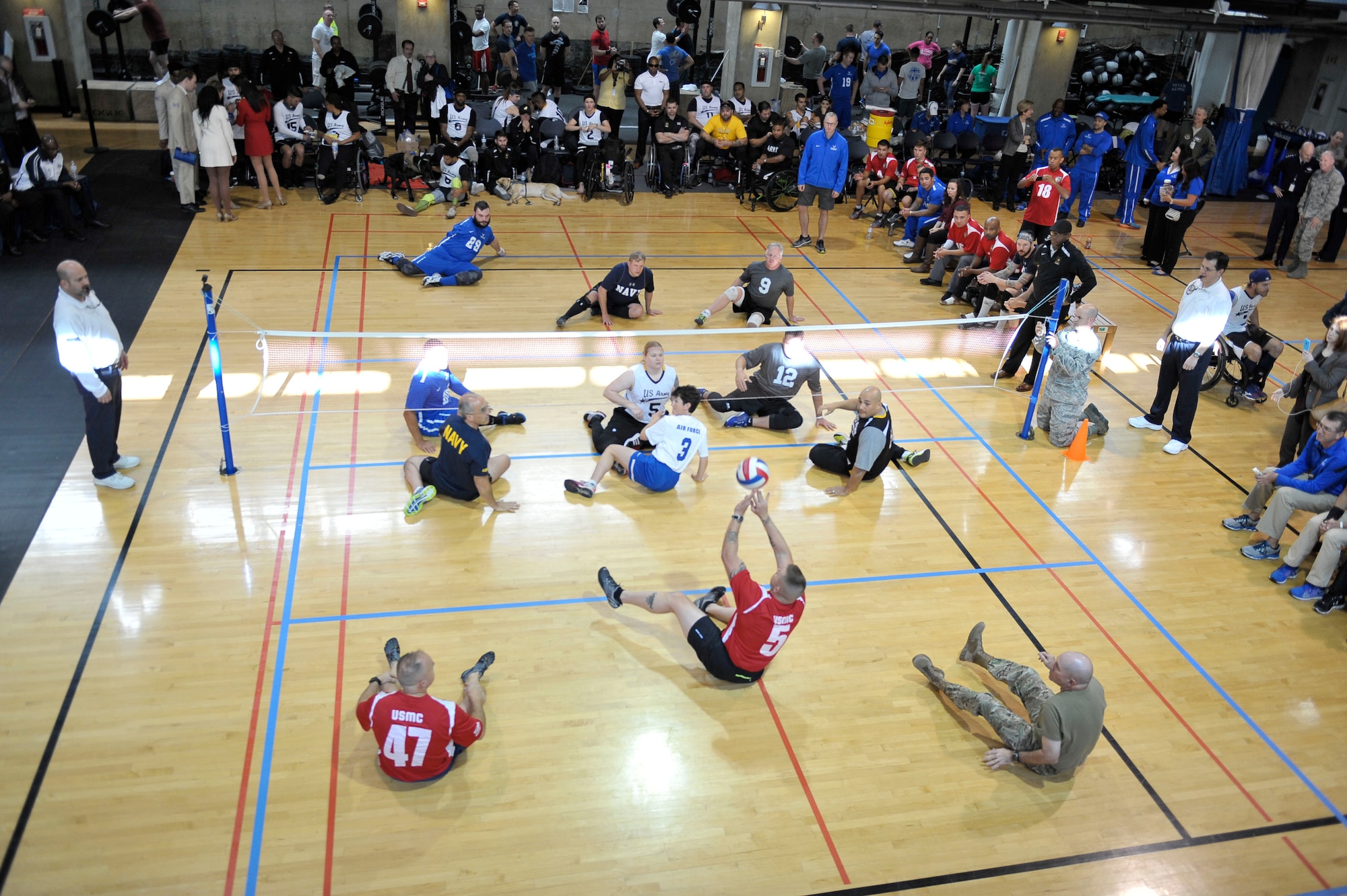 Wounded warrior athletes from the Army, Air Force, Navy and Marines compete against senior military leaders in the joint-service Warrior CARE Month Sitting Volleyball Tournament at the Pentagon Nov. 17, 2016. The warrior CARE event offers participants caregiver support and recovering Airmen mentorship, training and adaptive and rehabilitative sports training. CARE stands for Caregiver Support Program, Adaptive and Rehabilitative Sports Program, Recovering Airmen Mentorship Program, and Employment and Career Readiness Program. (U.S. Air Force photo/Tech. Sgt. Robert Barnett)