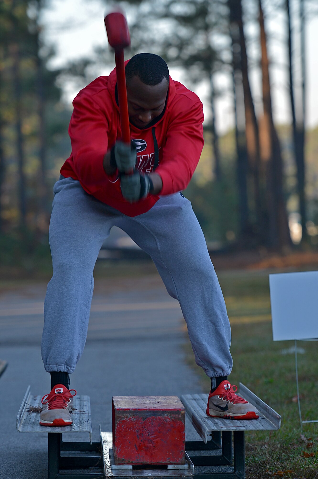 A U.S. Airman assigned to the 20th Fighter Wing hits a block with a hammer during a Firefighter Combat Challenge 5K Run at Shaw Air Force Base, S.C., Nov. 18, 2016. Airmen from various squadrons worked together in teams to complete obstacles created to test their physical endurance as well as build camaraderie following the conclusion of operational readiness exercise Weasel Victory 17-03. (U.S. Air Force photo by Airman 1st Class Christopher Maldonado)