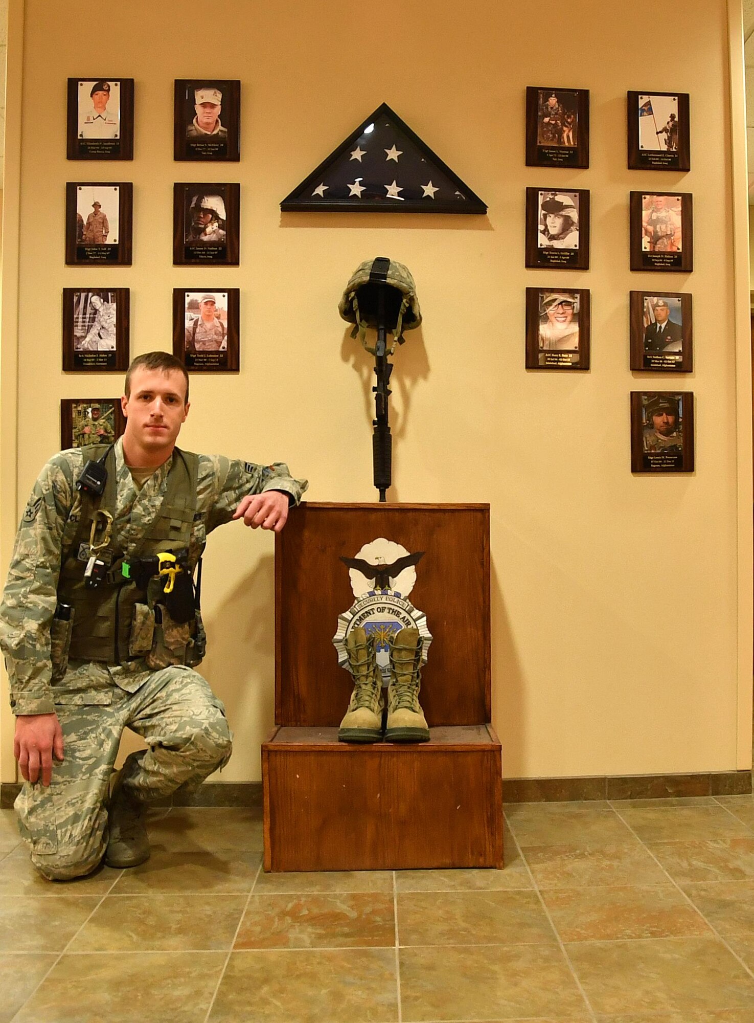 Senior Airman Zachary Clapper, 319th Security Forces Squadron patrolman, kneels in front of a security forces memorial on Grand Forks Air Force Base, N.D., Nov. 18, 2016. Clapper received the Airman 1st Class Elizabeth Jacobson Award for Expeditionary Excellence, an award named after the first defender killed in the line of duty in support of Operation Iraqi Freedom. (U.S. Air Force photo by Airman 1st Class Elijaih Tiggs)