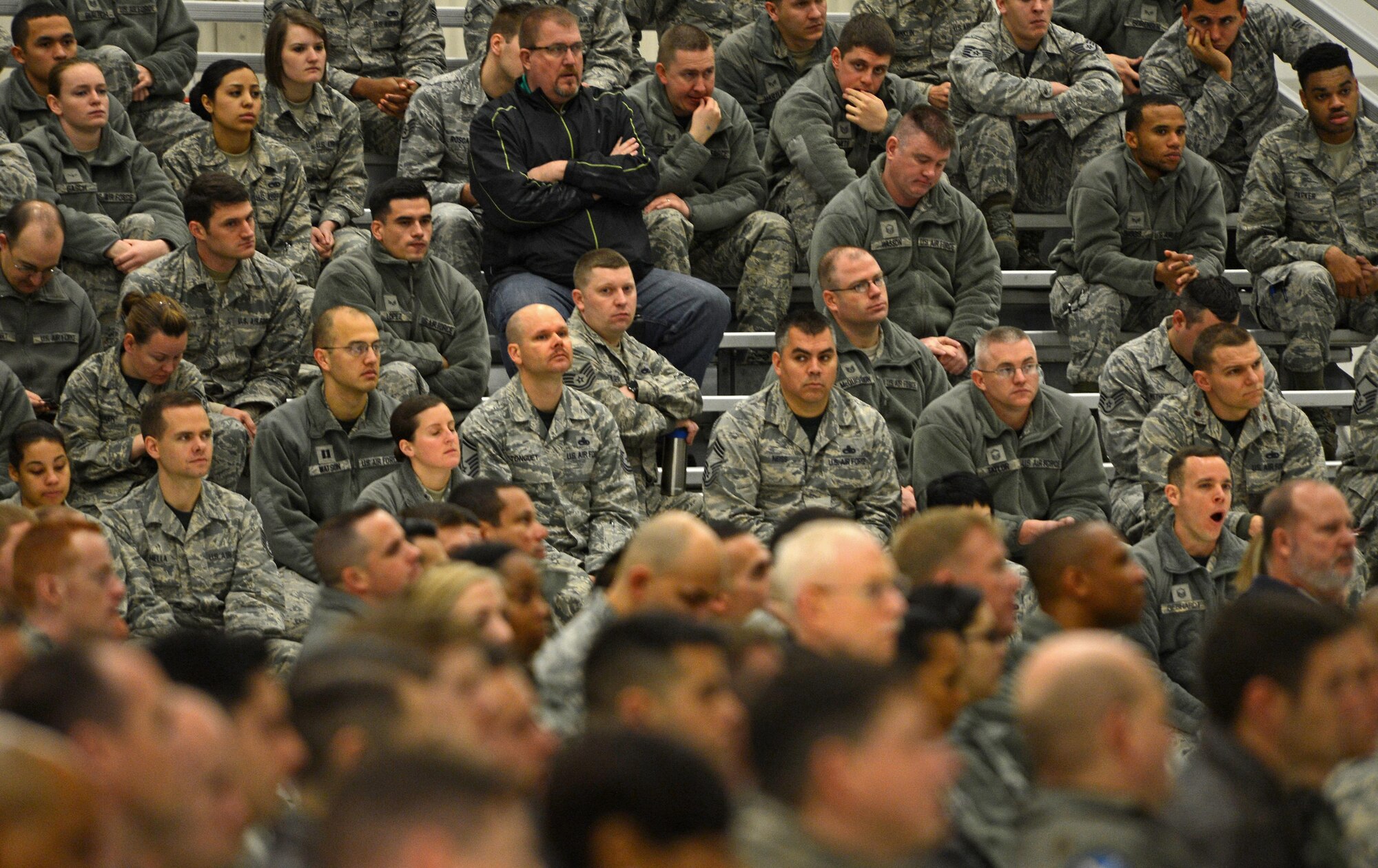 Airmen from Team McChord listen to a guest speaker for Wingman Day in hangar nine, Nov. 18, 2016 at Joint Base Lewis-McChord, Wash. Wingman Day kicked off with Airmen listening to guest speakers before being released back to their squadron for resiliency training. (U.S. Air Force photo/Senior Airman Divine Cox)