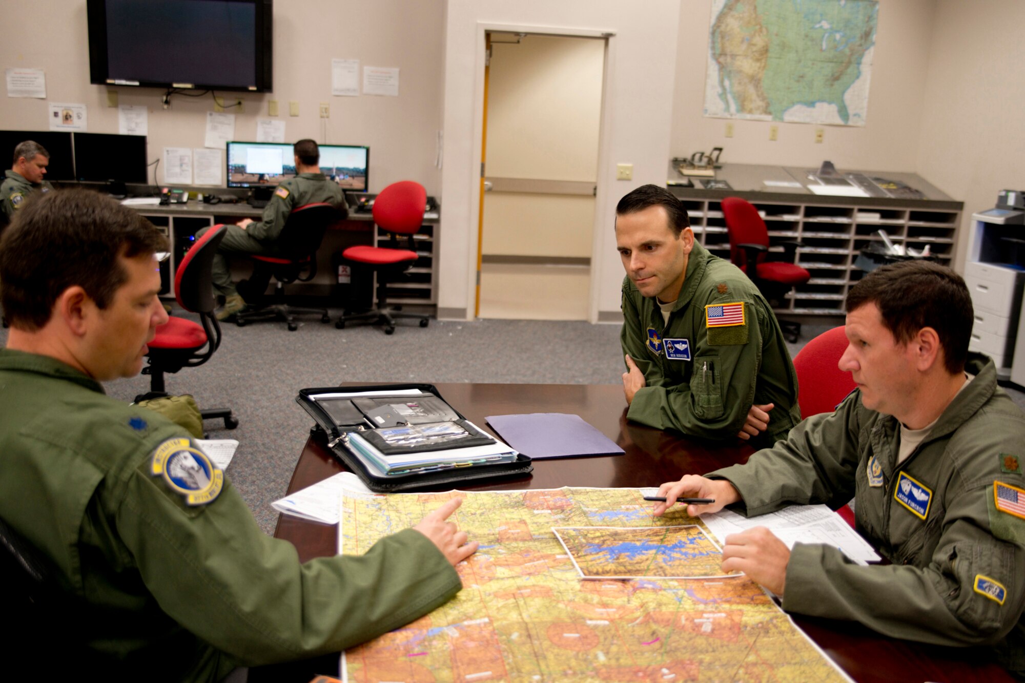 U.S. Air Force Reserve Lt. Col. Dan Collister, pilot, 327th Airlift Squadron, Maj. Ken Hodgson, instructor pilot, 62nd Airlift Squadron, and U.S. Air Force Reserve Maj. Jason Furcron, pilot, 327 AS, conduct a mission brief before competing in the “Turkey Shoot,” Nov. 17, 2016, at Little Rock Air Force Base, Ark. Hodgson was the umpire for the crew, evaluating times over target, ensuring rules of engagement were followed, and providing guidance for the parts of the mission not known to the crew prior to takeoff. This is the second time Airmen from the 913th Airlift Group have participated in the annual competition, which assesses the Airmen’s technical skills in different scenarios and determines which crew is really the best. Five units from Team Little Rock participated in the event. (U.S. Air Force photo by Master Sgt. Jeff Walston/Released) 