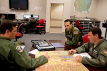U.S. Air Force Reserve Lt. Col. Dan Collister, pilot, 327th Airlift Squadron, Maj. Ken Hodgson, instructor pilot, 62nd Airlift Squadron, and U.S. Air Force Reserve Maj. Jason Furcron, pilot, 327 AS, conduct a mission brief before competing in the “Turkey Shoot,” Nov. 17, 2016, at Little Rock Air Force Base, Ark. Hodgson was the umpire for the crew, evaluating times over target, ensuring rules of engagement were followed, and providing guidance for the parts of the mission not known to the crew prior to takeoff. This is the second time Airmen from the 913th Airlift Group have participated in the annual competition, which assesses the Airmen’s technical skills in different scenarios and determines which crew is really the best. Five units from Team Little Rock participated in the event. (U.S. Air Force photo by Master Sgt. Jeff Walston/Released) 