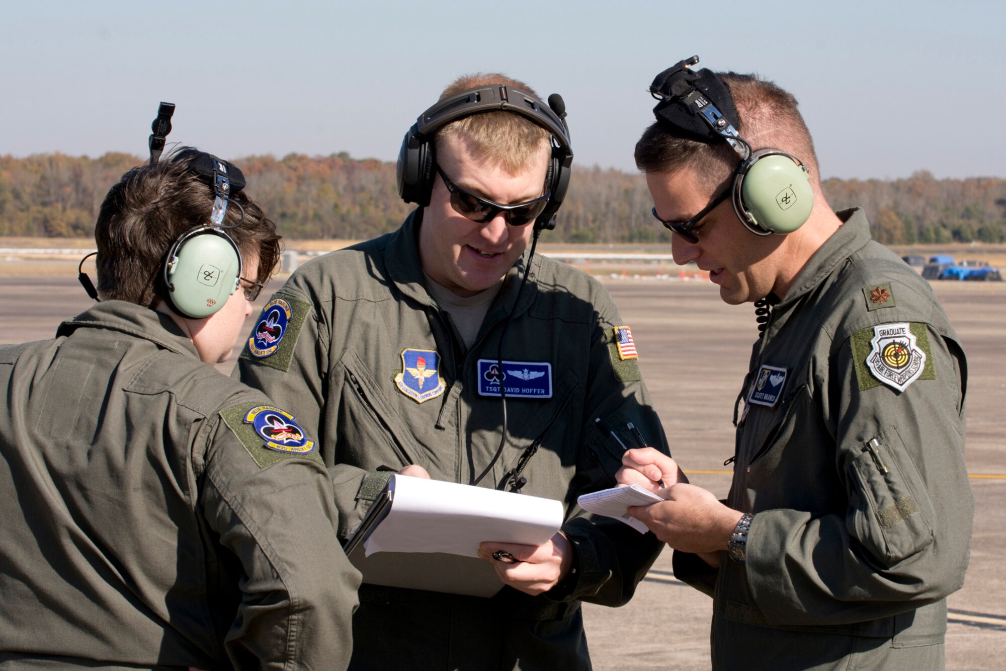 U.S. Air Force Maj. Scott Branco, pilot, 314th Operations Group, confers with “Turkey Shoot” competition umpires Tech Sgt. David Hoffer, loadmaster, 62nd Airlift Squadron, and Staff Sgt. Liz Patton, loadmaster, 62 AS, during the event, Nov. 17, 2016, at Little Rock Air Force Base, Ark. Branco, was the competition’s planner. Five units from Team Little Rock participated in the event, which evaluated the technical skills of the crews and how they may perform in real world situations. (U.S. Air Force photo by Master Sgt. Jeff Walston/Released) 
