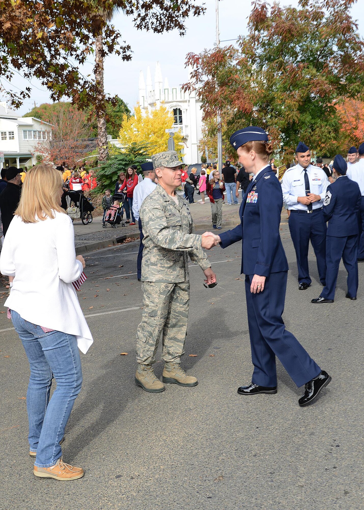 940th Air Refueling Wing commander, Col. Craig C. Peters, along with his wife, Cathie, take a moment before the parade starts to shake hands with Col. Danielle Barnes, 9th Mission Support Group commander, at the 14th Annual Yuba-Sutter Veterans Day parade on Nov. 11, 2016 in Marysville, California. Team Beale members marched in the parade to honor their local community’s support and recognize all veterans who have served and are serving. (U.S. Air Force photo by Sean Bhakta)