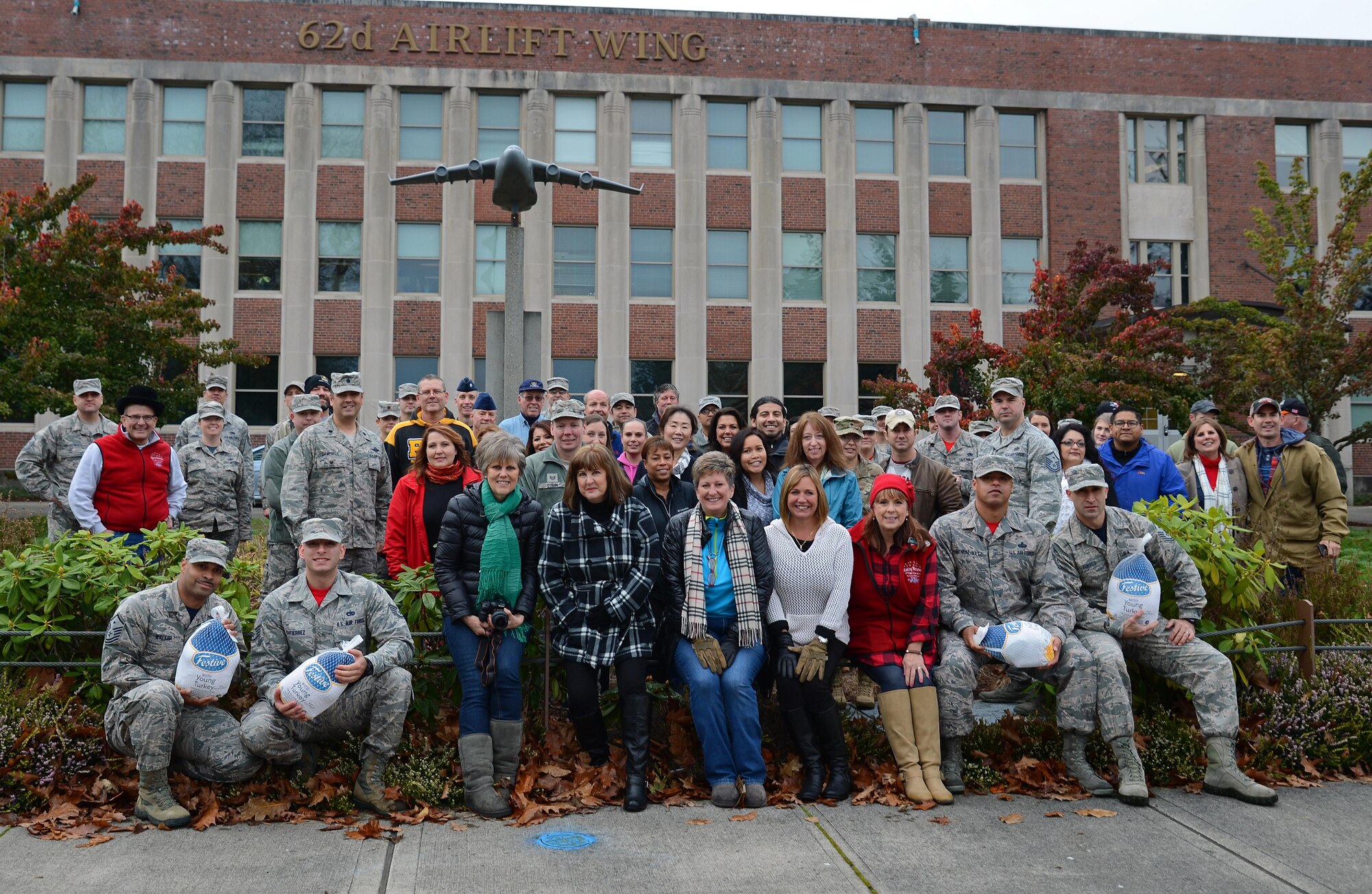 Team McChord leadership and community partners pose for a photo during the Annual Operation Turkey Drop, Nov. 18, 2016 at Joint Base Lewis-McChord, Wash. The event, in which frozen turkeys are donated to Service Members, is an annual event sponsored by local community partners, from the Puget Sound Area (U.S. Air Force photo/Senior Airman Jacob Jimenez)  