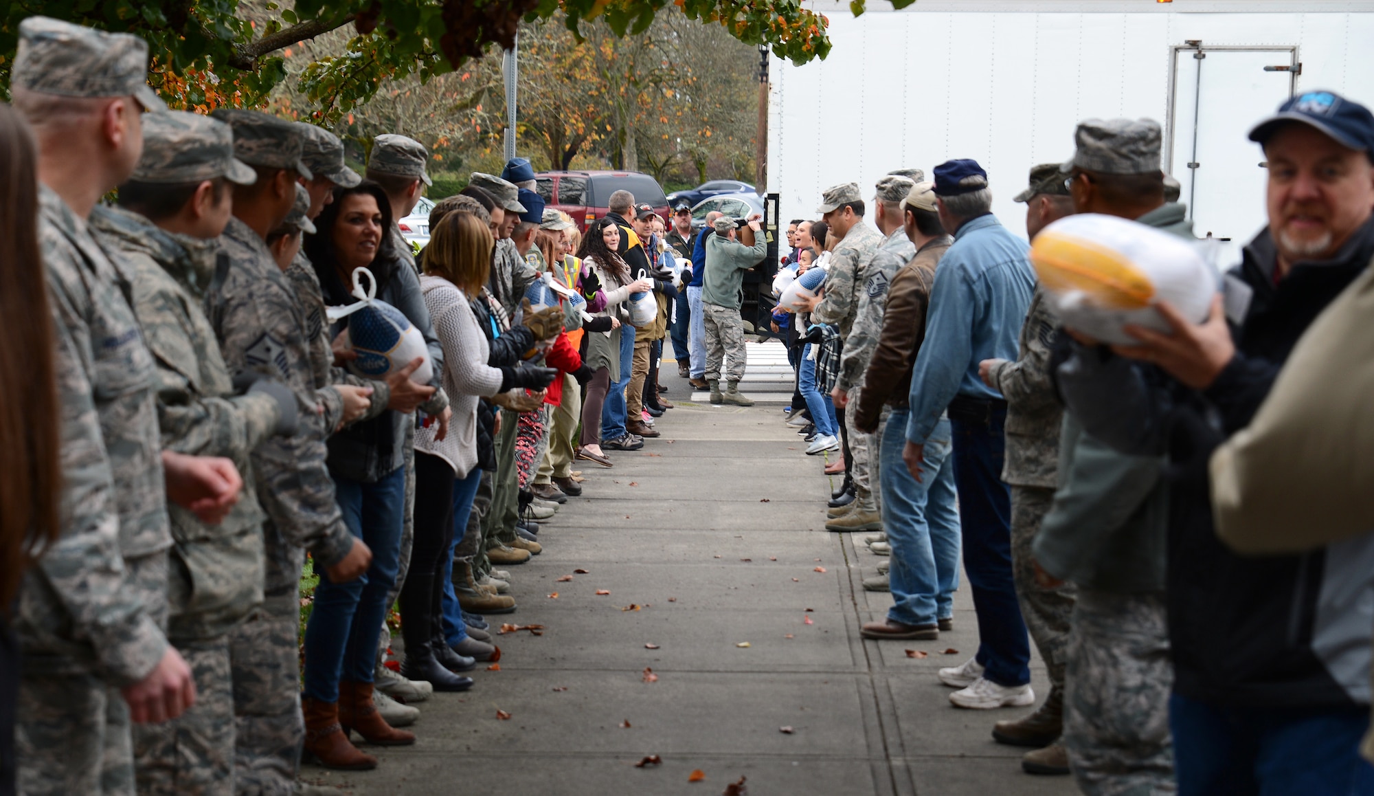 Community partners and Team McChord leadership unload turkeys during the Annual Operation Turkey Drop, Nov. 18, 2016 at Joint Base Lewis-McChord, Wash. Community partners donated 132 turkeys to active duty Team McChord Airmen during this year’s event. (U.S. Air Force photo/Senior Airman Jacob Jimenez)       