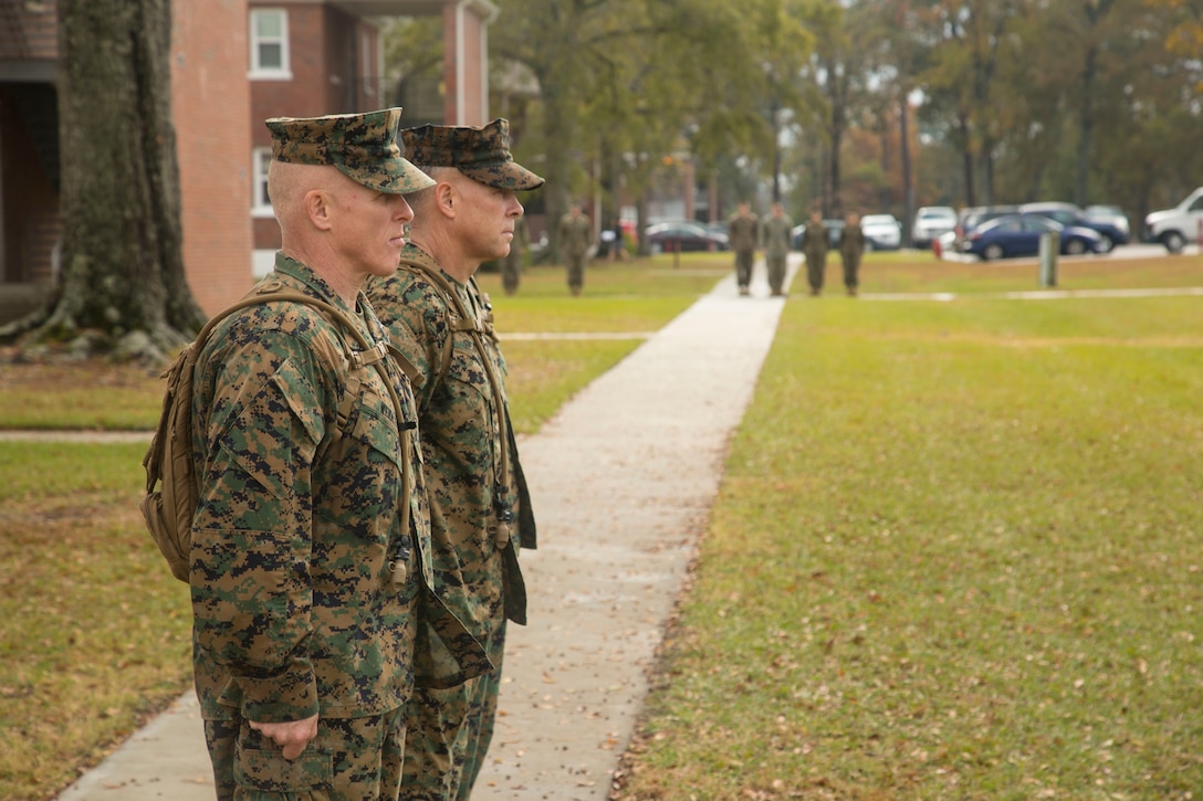 U.S. Marine Corps Brig. Gen. Thomas Weidley, left, commanding general, Marine Corps Installations East, Marine Corps Base Camp Lejeune (MCIEAST, MCB CAMLEJ), Col. Chandler Seagraves, center, commanding officer, Headquarters and Support Battalion (H&S Bn), MCIEAST, MCB CAMLEJ, and Sgt. Maj. Scott Grade, right, sergeant major, MCIEAST, MCB CAMLEJ, salute the colors during a hike on Camp Lejeune, Nov. 14, 2016. H&S Bn, MCIEAST, MCB CAMLEJ conducted a 7.5 mile motivational and educational hike in recognition of the 75th anniversary of Camp Lejeune.