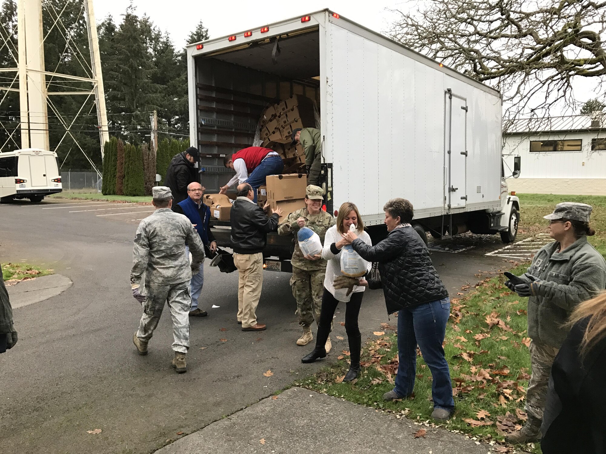 Volunteers and Airmen from the 446th Airlift Wing's Airman and Family Readiness Center help unload turkey from a truck as part of the annual Turkey drop on the Rainier Wing. The Puget Sound Business Alliance partnered with the 446th AW to donate 83 Turkeys as part of an ongoing Thanksgiving food drive effort taking place on the Rainier Wing to provide Airmen in need with a Thanksgiving meal. (U.S. Air Force photo by Staff Sgt. Daniel Liddicoet)