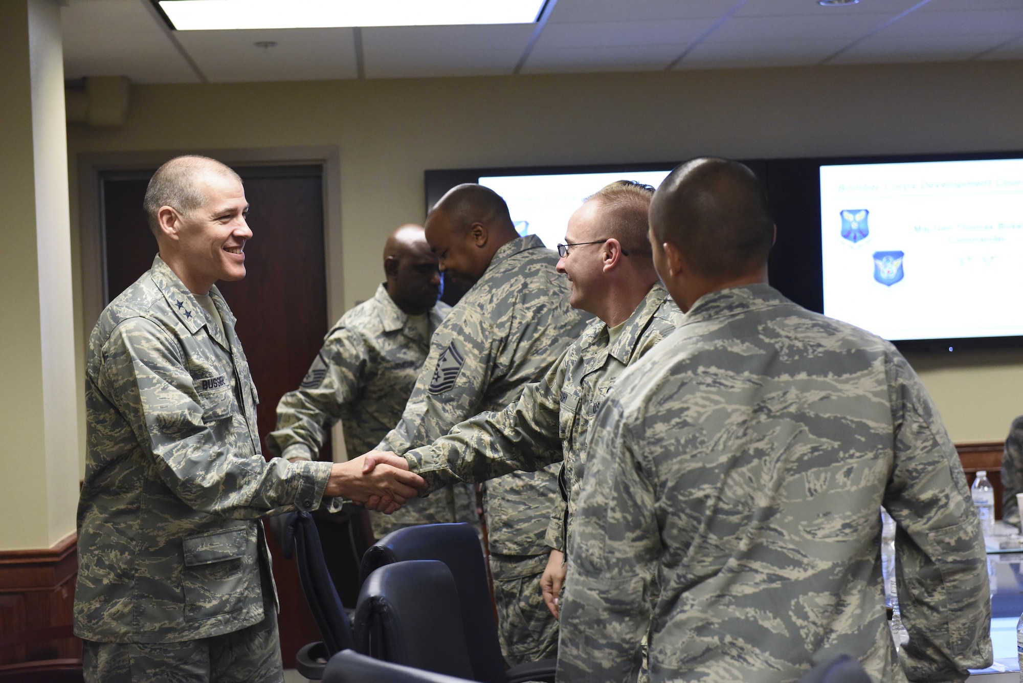 U.S. Air Force Maj. Gen. Thomas Bussiere, 8th Air Force commander, greets Airmen attending a Bomber Corps Development Course at Barksdale Air Force Base, La., Nov. 17, 2016. The Airmen in attendance came to Barksdale from various Air Force Global Strike Command bases to enhance their understanding of the multifaceted 8th Air Force mission, heritage, culture and more. Courses are held to further assist educating flight and squadron level leaders about the 8th Air Force mission. (U.S. Air Force photo/Airman Alexis Schultz)