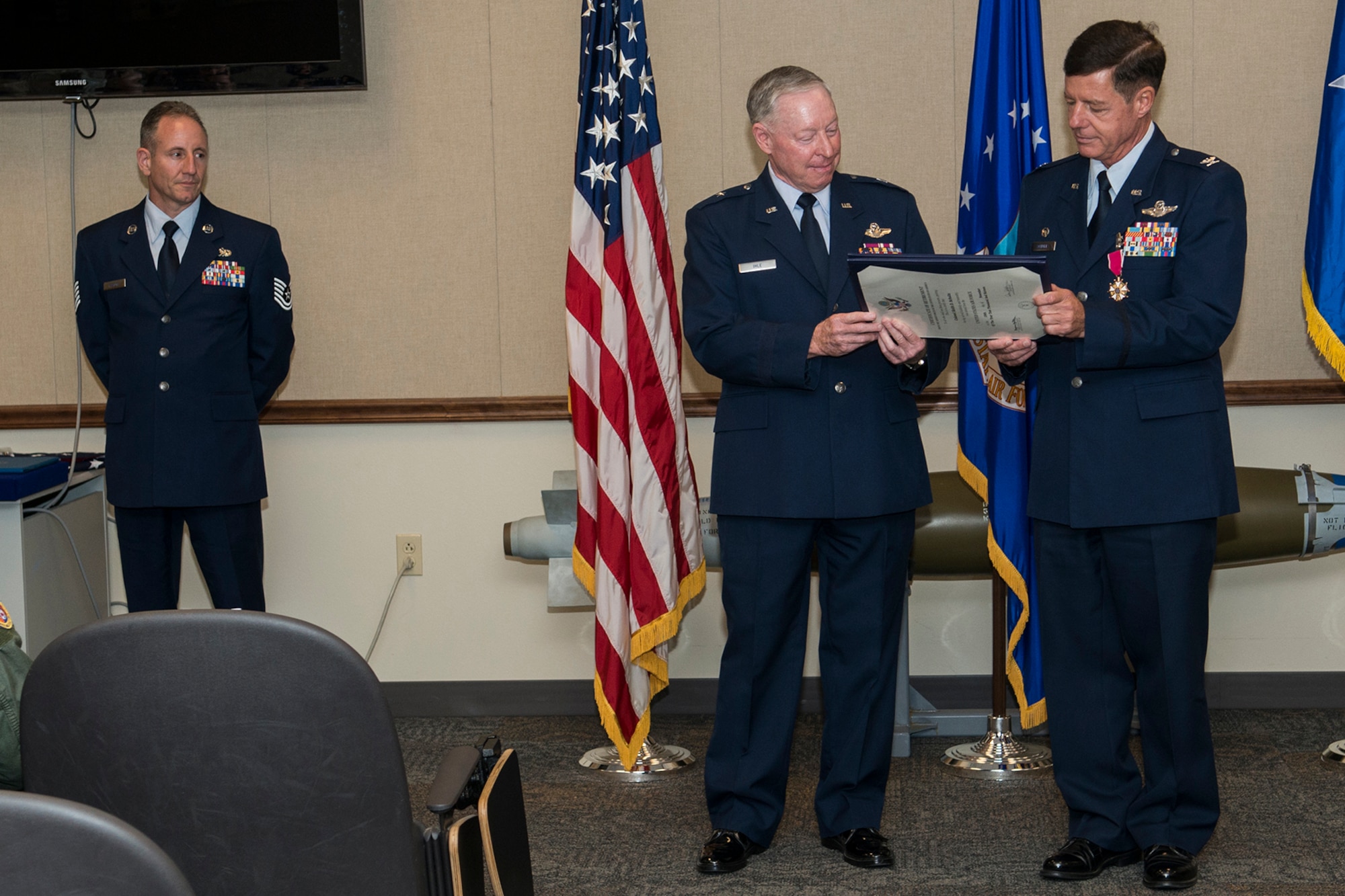U.S. Air Force retired Brig. Gen. Jack Ihle, former 307th Bomb Wing commander, and Col. Keith Schultz (right) read the retirement order during a ceremony on Nov. 18, 2016, Barksdale Air Force Base, La. Schultz, the former 307th Operations Group commander, is a B-52H Stratofortress pilot and is retiring after serving more than 30 years in the Air Force. (U.S. Air Force photo by Master Sgt. Greg Steele/Released)