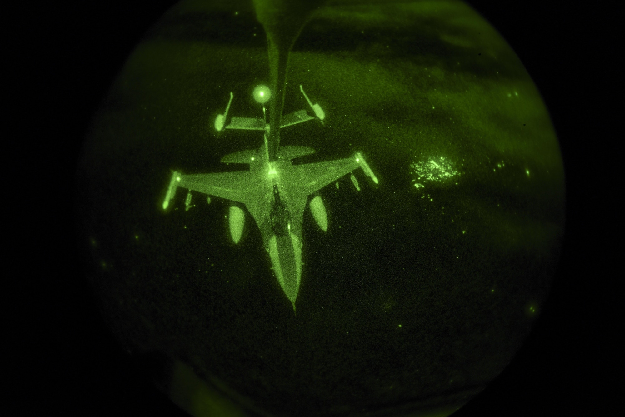 An F-16 Falcon refuels midair during exercise Combat Raider at the Powder River Training Complex near Belle Fouche S.D., on Nov. 15, 2016. Combat Raider is a large force exercise testing several agency’s cohesion and coordination while completing several large-scale objectives. (U.S. Air Force photo by Airman 1st Class Randahl J. Jenson)