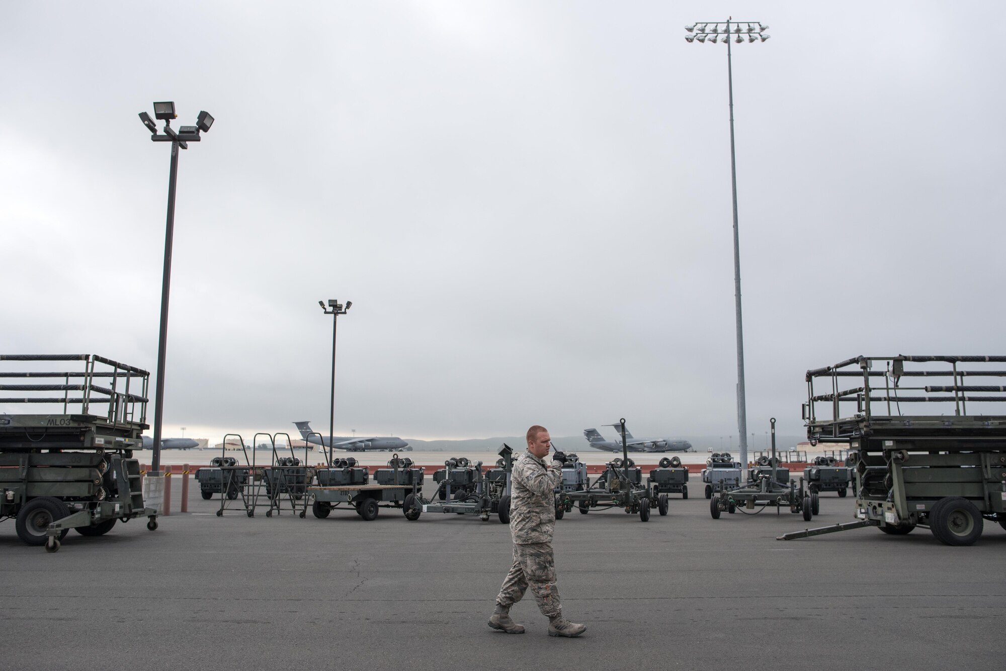 Senior Airman Thomas Ribeiro, 60th Aerospace Ground Equipment Flight mechanic, walks through a ready line of equipment staged to support aircraft mechanics and crew chief on a moment’s notice at Travis Air Force Base, Calif., on Nov. 15, 2016. Ribeiro currently works as a dispatcher and a kind of “roving mechanic,” helping keep aircraft maintenance on schedule. The AGE shop provides more than 500 pieces and 53 types of equipment 24 hours per day, every day. (U.S. Air Force photo by Ken Wright)