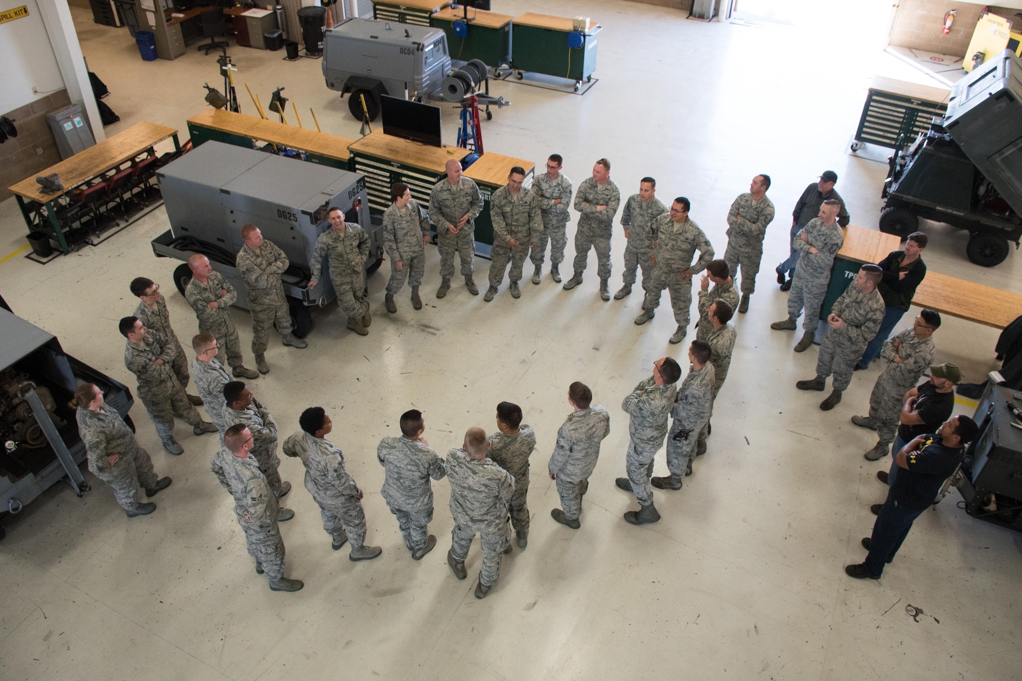 Airmen and civilians from the 60th Air Mobility Wing and 349th AMW meet to discuss work priorities and unit events at the integrated 60th AMW/349th AMW Aerospace Ground Equipment Flight, at Travis Air Force Base, Calif, on Nov. 15, 2106. The combination of active duty Airmen, reservists and civilians create an AGE flight rich with the skills, knowledge and experience necessary to satisfy busy flight line operations . (U.S. Air Force photo by Ken Wright)