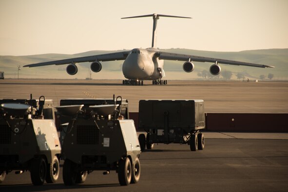 A C-5M Super Galaxy taxies at Travis Air Force Base, Calif., on Nov. 15, 2016. Airmen and civilians from the integrated 60th /349th Aerospace Ground Equipment Flights, work together day and night to provide generators, flood lights and other equipment necessary for aircraft mechanics to keep the base’s aircraft and transient aircraft mission-ready. (U.S. Air Force photo by Ken Wright)