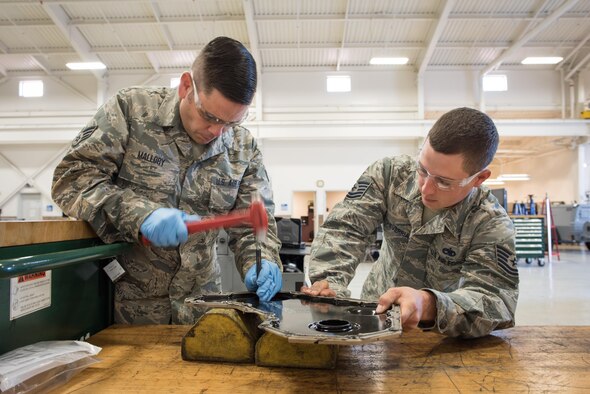 Staff Sgt. Cody Etcheverria instructs Senior Airman Justin Mallory on how to properly replace a generator’s crank shaft seal at Travis Air Force Base, Calif., on Nov. 15, 2016. Etcheverria is an air reserve technician, and Mallory is a traditional reservist assigned to the 60th/349th Aerospace Ground Equipment Flight. Mallory, who recently joined the reserve 11 years after separating from active duty, was taking part in seasoning training, which helps reservists in upgrade training get the experience they need to progress. (U.S. Air Force photo by Ken Wright)