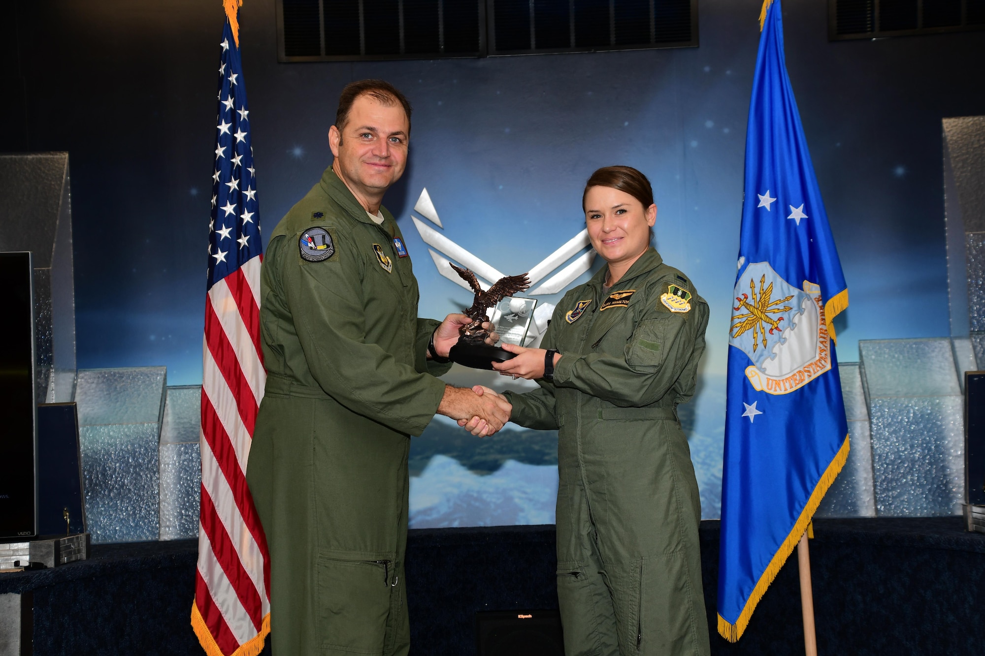 U.S. Air Force Col. Ty Neuman, commander of the 2nd  Bomb Wing, presents the Pilot Distinguished Graduate Award to Capt. Shaun Bean during a Formal Training Unit (FTU) graduation ceremony, November 18, 2016, Barksdale Air Force Base, La. Bean graduated from the FTU as a pilot on the B-52H Stratofortress. (U.S. Air Force photo by Master Sgt. Laura Siebert /Released)