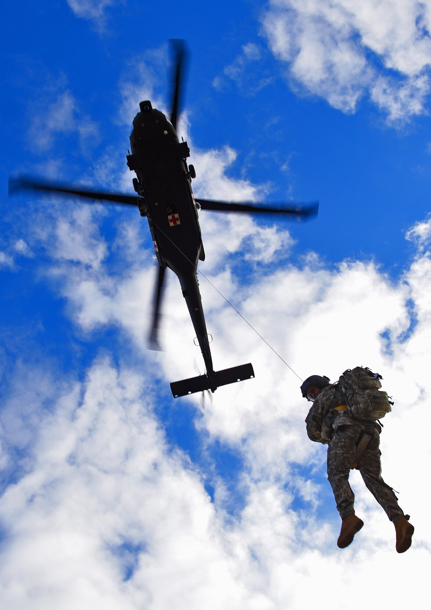 A soldier from the South Dakota National Guard’s Company C, 1st Battalion, 189th Aviation Regiment, descends from an UH60 Blackhawk helicopter during Exercise Combat Raider 1701 near Belle Fourche, S.D., Nov. 16, 2016. The exercise simulated rescuing two injured pilots that ejected from their aircraft in hostile territory. (U.S. Air Force photo by Airman 1st Class James L. Miller)