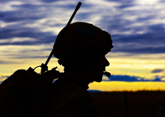 A joint terminal attack controller assigned to the 5th Air Support Operations Squadron, Joint Base Lewis-McChord, Wash., performs a radio check before a B-1 bomber flyby near Belle Fourche, S.D., Nov. 16, 2016. The fly-by was part of a show-of-force before a rescue helicopter could proceed to the area. (U.S. Air Force photo by Airman 1st Class James L. Miller) 