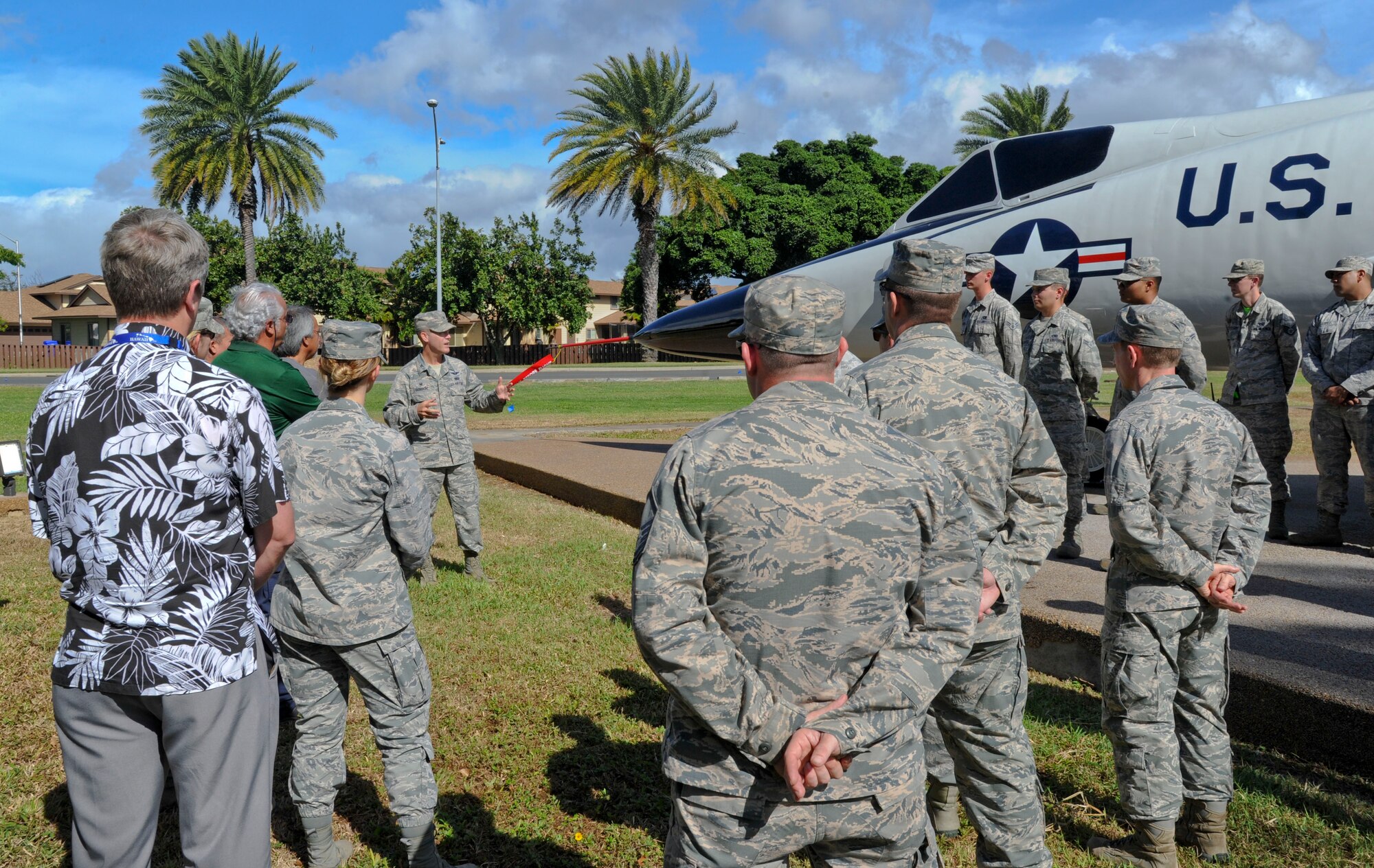 Col. Kevin Gordon, 15th Wing commander, talks to a crowd of Airmen before the ribbon cutting of the static F-102 aircraft on Joint Base Pearl Harbor-Hickam, Hawaii, Nov. 18, 2016. The aircraft recently underwent an extensive full-body restoration, which included sanding off corrosion, new paint, and new patches. Airmen from the 15th Aircraft Maintenance Squadron headed the restoration project. (U.S. Air Force photo by Tech. Sgt. Terri Paden/Released)
