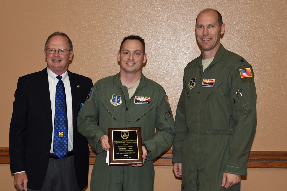 Cliff Jones, Tempe Military Affairs Committee member, and U.S. Air Force Col. Troy Daniels, 161st Air Refueling Wing commander, present the Maj. Truman Young award to Lt. Col. Jeremy Lopes during a ceremony Nov. 15, 2016 at the wing. (U.S. Air National Guard photo by Master Sgt. Kelly Deitloff)