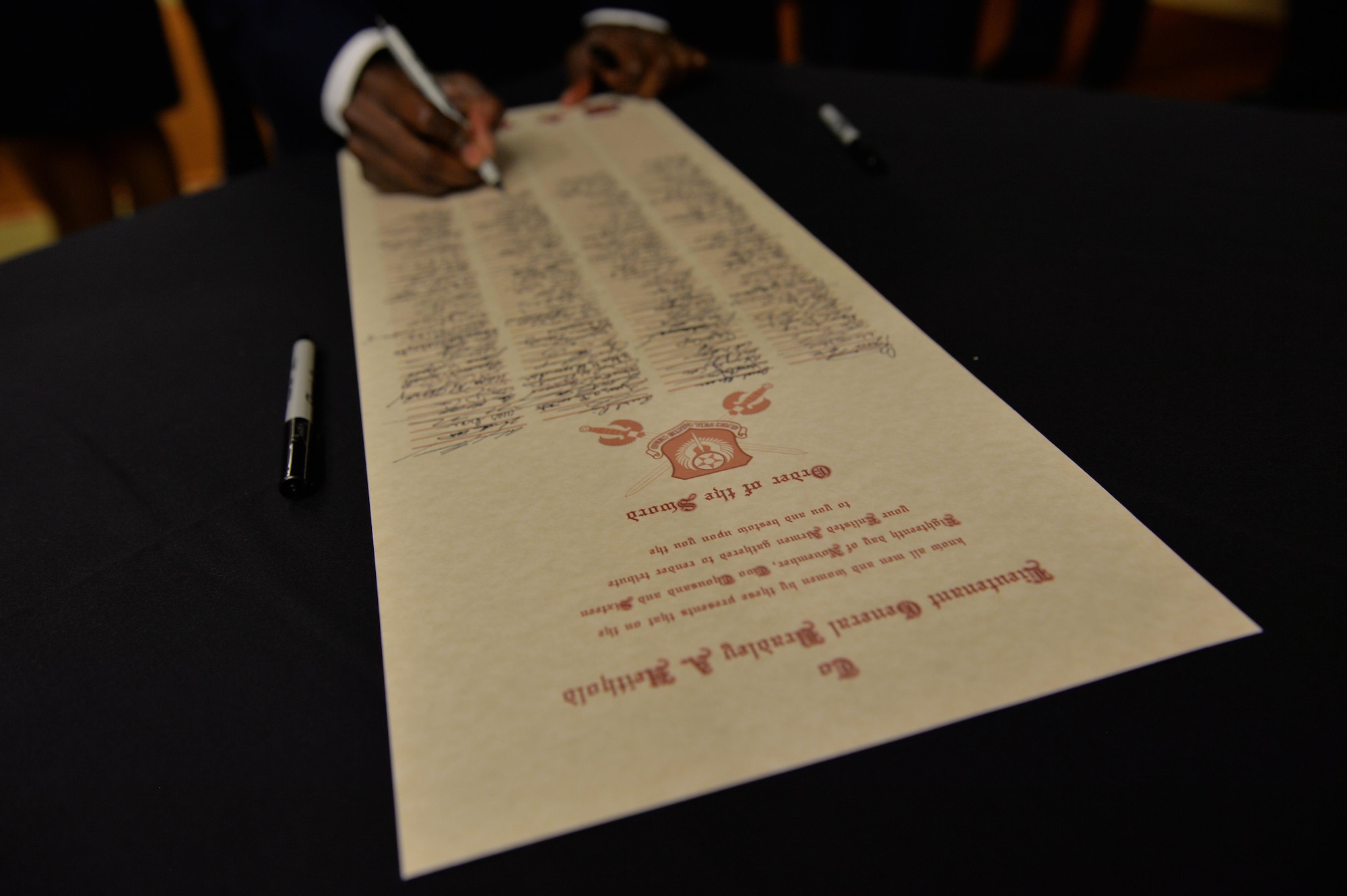 Air Commandos sign the Order of the Sword Proclamation before the ceremony at Hurlburt Field, Fla., Nov. 18, 2016. The ceremony honored Lt. Gen. Brad Heithold, the former commander of Air Force Special Operations Command, for his significant contributions to the enlisted force. (U.S. Air Force photo by Senior Airman Andrea Posey)