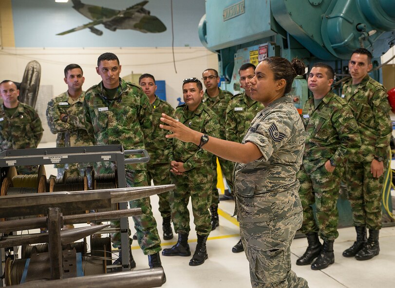 Tech. Sgt. Stephanie Rymers, 433rd Maintenance Squadron sheet metal mechanic, explains the sheet metal fabrication process to Inter-American Air Forces Academy students Nov. 17, 2016 at Joint Base San Antonio-Lackland, Texas. The students also toured a C-5M Galaxy and the engine and structural shops at the 433rd Airlift Wing.  (U.S. Air Force photo by Benjamin Faske)