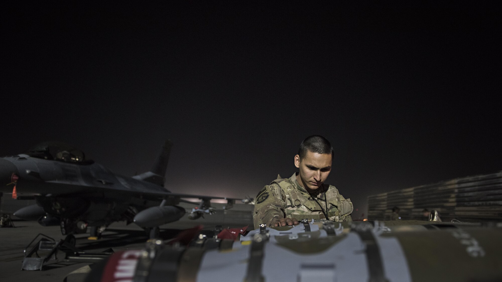 Senior Airman Zachary Manzella, 455th Expeditionary Aircraft Maintenance Squadron line delivery crew chief, delivers munitions to an F-16 Fighting Falcon Nov. 15, 2016 at Bagram Airfield, Afghanistan. Members of the 455th EAMXS enable multiple combat sorties daily out of Bagram. (U.S. Air Force photo by Staff Sgt. Katherine Spessa)
