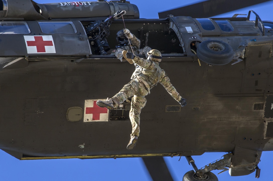 An airman with the 227th Air Support Operations Squadron, New Jersey Air National Guard, is pulled from a rooftop to a hovering New Jersey Army National Guard UH-60 Black Hawk medevac helicopter during a training exercise at Island Beach State Park, Seaside Park, N.J., Nov. 18, 2016. Air National Guard photo by Master Sgt. Mark C. Olsen