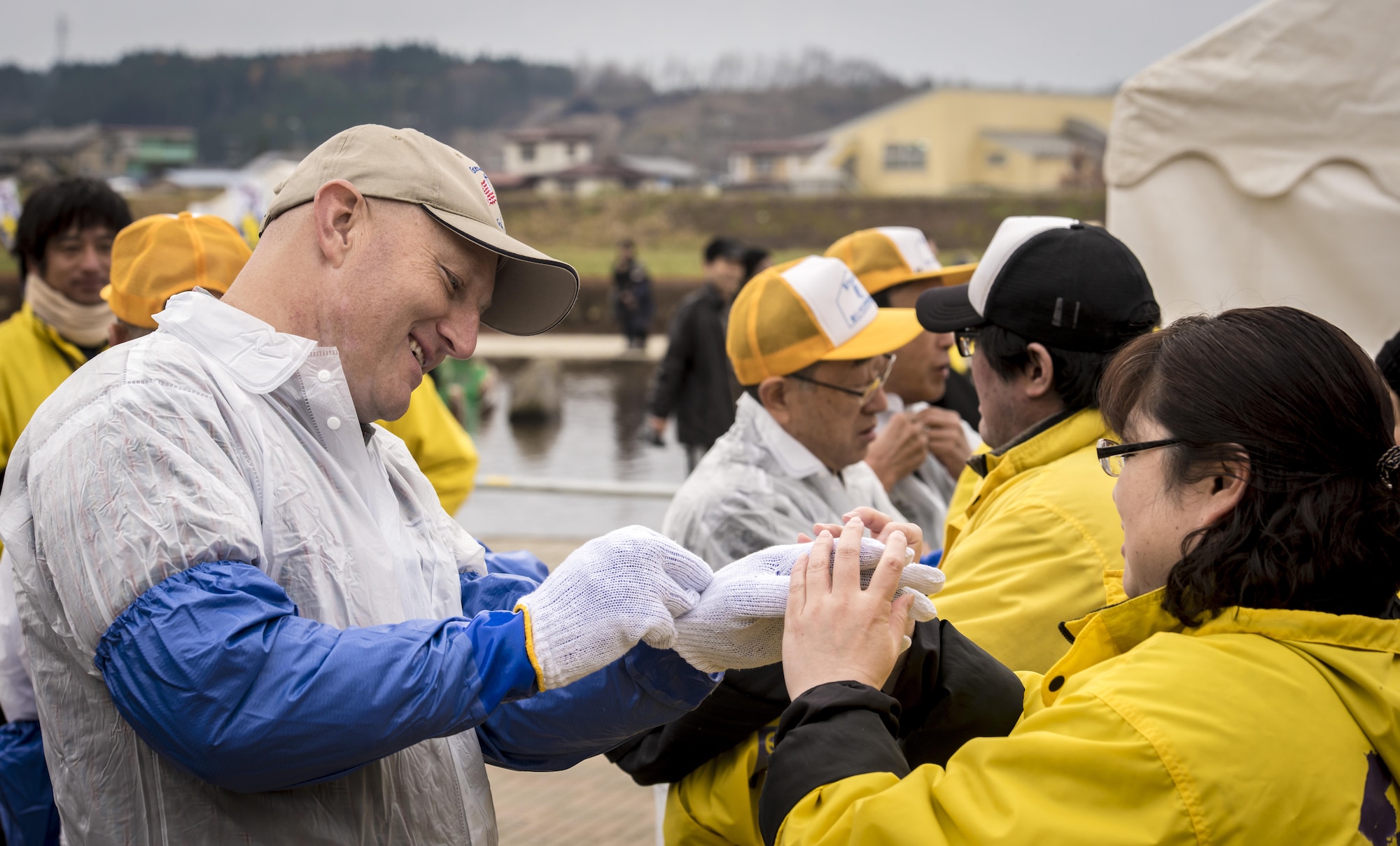 U.S. Air Force Col. Travis Rex, the 35th Fighter Wing vice commander, dons personal protective gear and waterproofing prior to joining several other regional Japanese leaders for the opening salmon catching demonstration to the 11th Annual Salmon Festival in Oirase, Japan, Nov. 19, 2016. After catching the salmon, event attendees learned how to properly fillet their prizes. The event included salmon racing, dozens of food booths and numerous music performances. (U.S. Air Force photo by Staff Sgt. Benjamin W. Stratton)