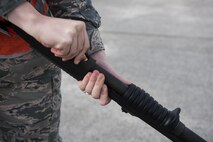 U.S. Air Force Senior Airman Monika Neal, 18th Operations Support Squadron airfield management operations coordinator, loads a shotgun with a pyrotechnic round to scare off a flock of birds on the runway Nov. 16, 2016, at Kadena Air Base, Japan. The pyrotechnic round is like a small firecracker, it only makes a noise to scare the birds away from passing aircraft and doesn’t harm them. (U.S. Air Force photo by Airman 1st Class Corey M. Pettis/Released)