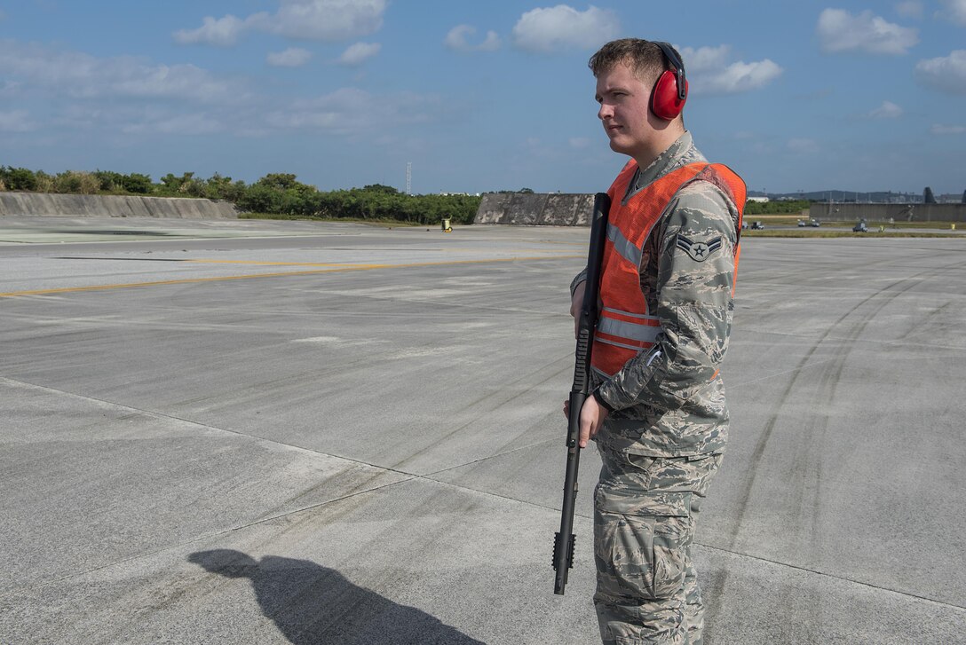U.S. Air Force Airman 1st Class Caleb Berstler, 18th Operations Support Squadron airfield management operations coodrinator, looks for birds to scare off the runway Nov. 16, 2016, at Kadena Air Base, Japan. Birds will sometimes fly into the path of oncoming aircaft and either be struck or sucked into the engines. (U.S. Air Force photo by Airman 1st Class Corey M. Pettis/Released)