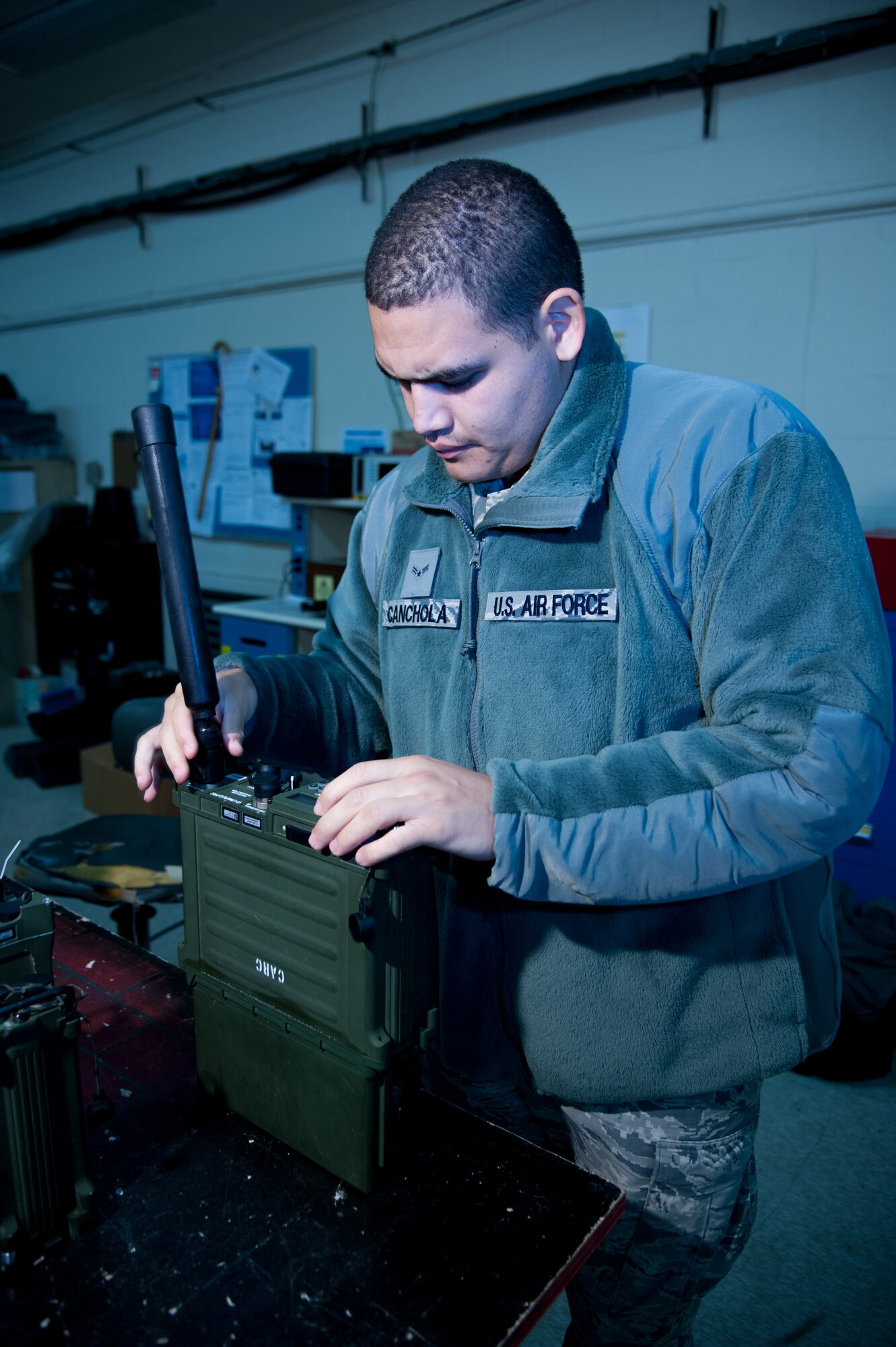 U.S. Air Force Airman 1st Class Sonny Canchola, 51st Communications Squadron radio frequencies transmissions system technician, assembles a PRC-117F Multiband Manpack Radio at Osan Air Base, Republic of Korea, Nov. 17, 2016. Canchola helps maintain Osan’s land radios to ensure base-wide communications. (U.S. Air Force photo by Staff Sgt. Jonathan Steffen)