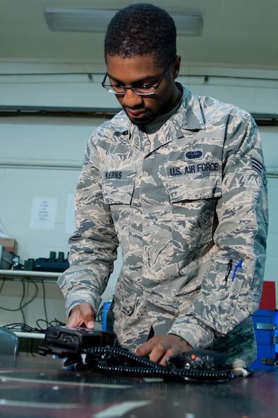 U.S. Air Force Senior Airman Dangelo Kerns, 51st Communications Squadron radio frequencies transmissions system technician, encrypts a land mobile radio at Osan Air Base, Republic of Korea, Nov. 17, 2016. Kerns and other Airmen from the transmission systems flight maintain and issue the mobile land radios to Team Osan members. (U.S. Air Force photo by Staff Sgt. Jonathan Steffen