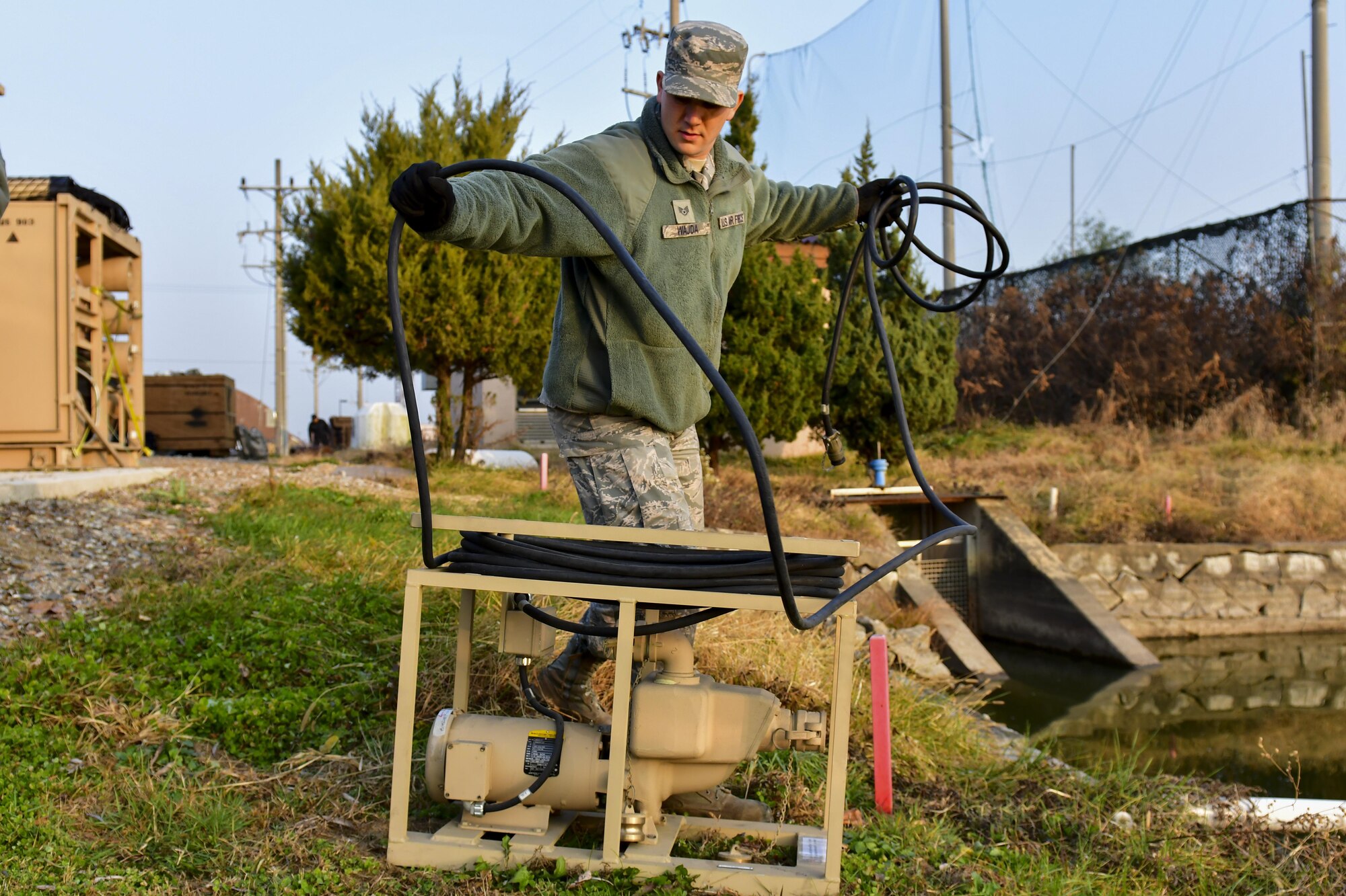 U.S. Air Force Staff Sgt. James Wajda, 51st Civil Engineer Squadron water fuels systems maintenance craftsman, sets up a raw water pump at Osan Air Base, Republic of Korea, Nov. 17, 2016. The pump is used to push water into a filtration system to generate large quantities of drinkable water for the base population. (U.S. Air Force photo by Senior Airman Victor J. Caputo)