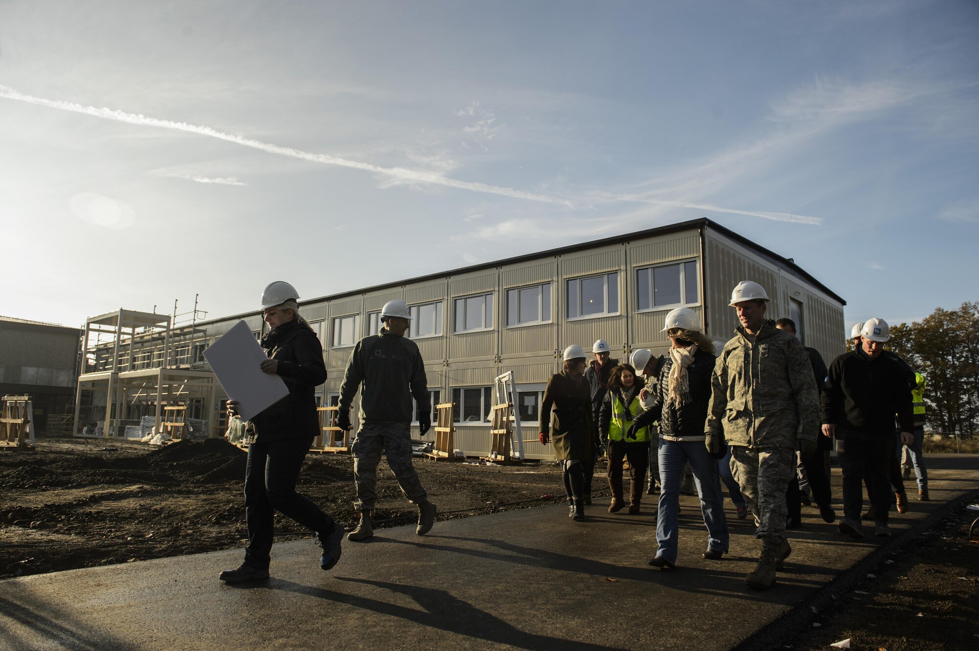 Sabine Metzen, 52nd Civil Engineer Squadron project manager, shows 52nd Fighter Wing leadership and school leadership around the new modular buildings being built on Spangdahlem Air Base, Germany, Nov. 14, 2016. The design and execution of the elementary school expansion project was a collaborative effort between Depart of Defense Education Activity, school leadership and 52nd CES. (U.S. Air Force photo by Staff Sgt. Jonathan Snyder)