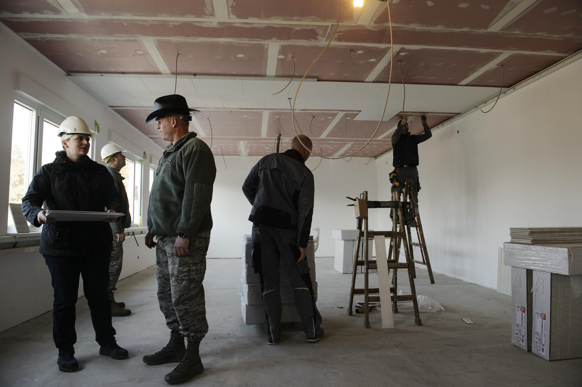 Col. Joe Mcfall, 52nd Fighter Wing commander, front right, talks with Sabine Metzen, 52nd Civil Engineer Squadron project manager, front left, during a tour around the new modular buildings being built for the elementary school on Spangdahlem Air Base, Germany, Nov. 14, 2016. The two new buildings include 14 classrooms, which will allow all elementary students to be on one campus. (U.S. Air Force photo by Staff Sgt. Jonathan Snyder)