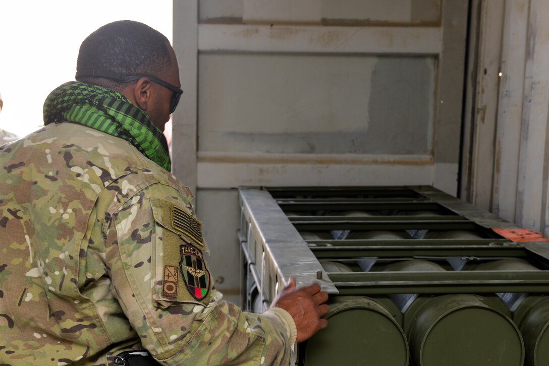 Master Sgt. Rick Page, Train, Advise, Assist Command-Air (TAAC-Air) occupational safety advisor, looks at weapons stored in a facility at Mazar-e-Sharif, Afghanistan, Nov. 17, 2016. Page traveled from Hamid Karzai International Airport to perform a site visit and discuss upcoming munitions field depot construction with the Army Corps of Engineers. (U.S. Air Force photo by Tech. Sgt. Christopher Holmes)