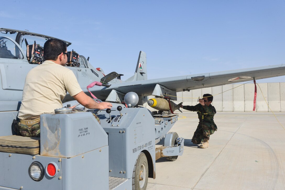 Weapons troops from the Afghan Air Force offload Mark-81 bombs from an A-29 Super Tucano at Mazar-e-Sharif, Afghanistan, Nov. 18, 2016. The squadron here is the only AAF unit fully capable of managing entire missions from assembling bombs to flying missions with minimal assistance from coalition advisors. (U.S. Air Force photos by Tech. Sgt. Christopher Holmes)