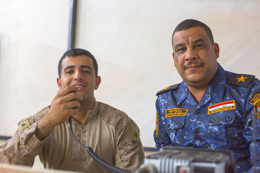 U.S. Marine Corps Cpl. Ali Mohammed, left, a member of the 3rd Battalion, 7th Marine Regiment, Special Purpose Marine Ground Air Task Force – Crisis Response – Central Command advise and assist team, poses for a photo with a member of the Iraqi security forces his team advises, Oct. 23, 2016, at Qayyarah West Airfield, Iraq. The Marines, alongside Soldiers from the 1st Squadron, 75th Regiment of the U.S Army’s 101st Airborne Division (Air Assault), are aiding the ISF as they retake territory from Islamic State of Iraq and the Levant. (U.S. Army photo by Spc. Christopher Brecht)