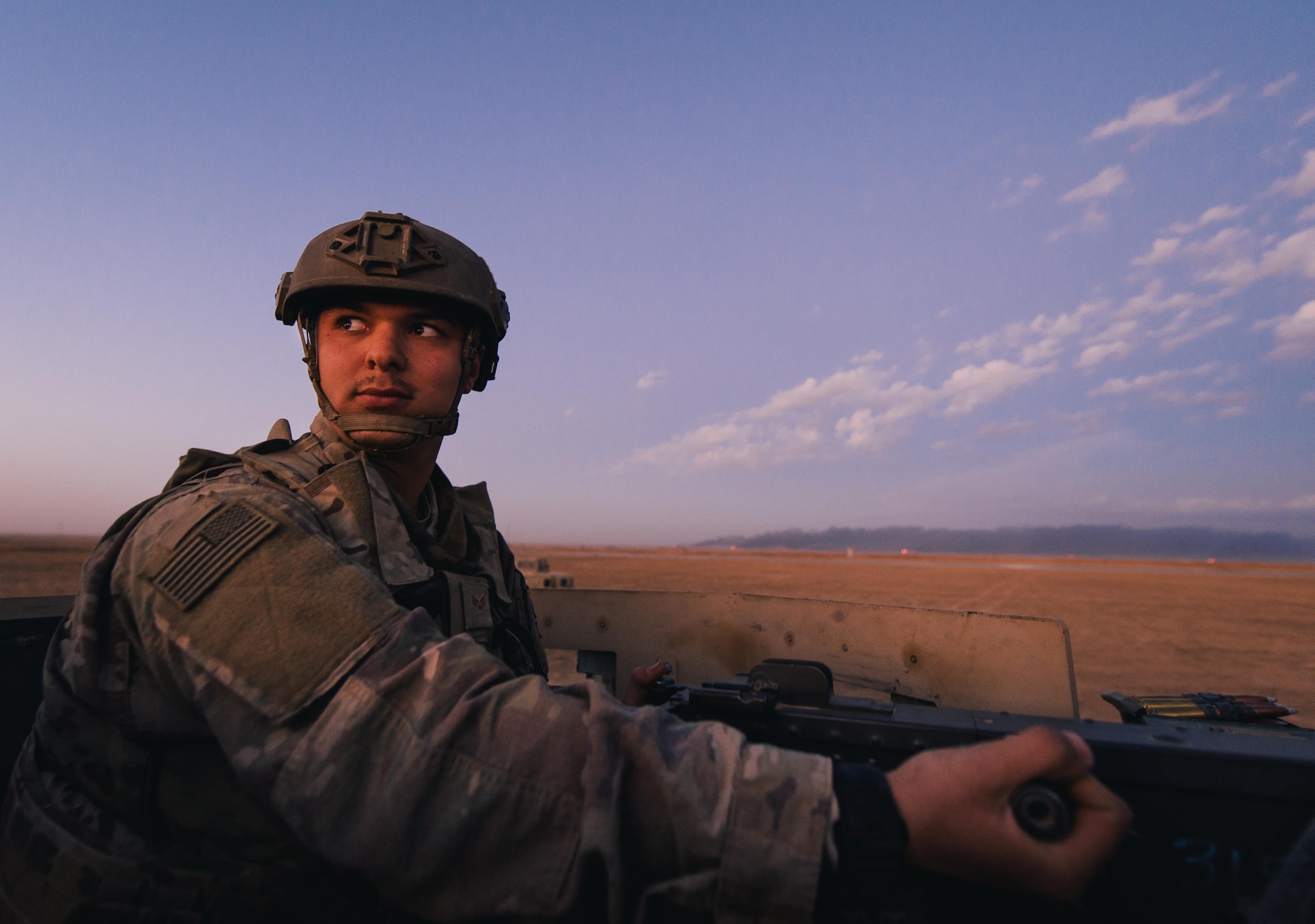 U.S. Air Force Senior Airman Anthony Wachob, 821st Contingency Response Group first in security team leader, scans the horizon from a defensive fighting position while on perimeter watch at Qayyarah West Airfield, Iraq, Nov. 17, 2016. The 821st CRG is highly-specialized in training and rapidly deploying personnel to quickly open airfields and establish, expand, sustain and coordinate air mobility operations in austere, bare-base conditions. (U.S. Air Force photo by Senior Airman Jordan Castelan)