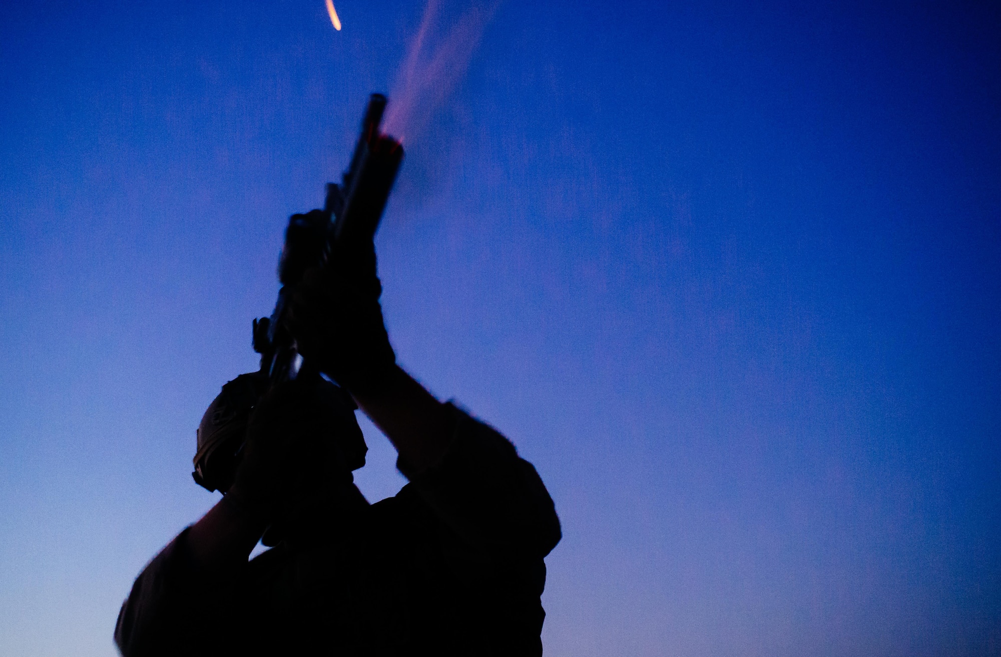 U.S. Air Force Staff Sgt. Steven Armbright, 821st Contingency Response Group first in security team member, fires a flare from a defensive fighting position while on perimeter watch at Qayyarah West Airfield, Iraq, Nov. 17, 2016. The 821st CRG is highly-specialized in training and rapidly deploying personnel to quickly open airfields and establish, expand, sustain and coordinate air mobility operations in austere, bare-base conditions. (U.S. Air Force photo by Senior Airman Jordan Castelan)